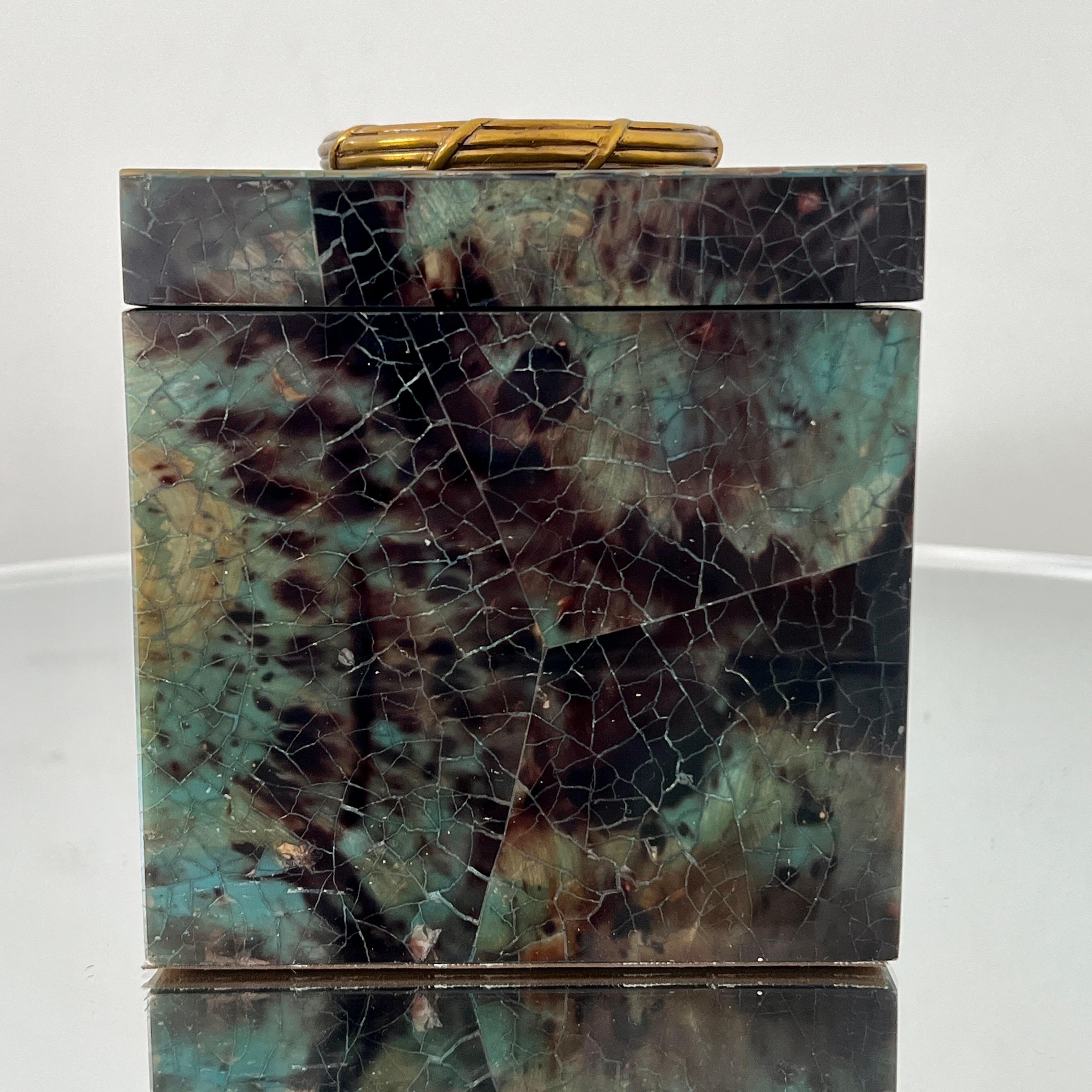 Decorative box all handcrafted in exotic materials featuring lacquered and hand dyed pen-shell over a wood frame. The box features mosaic shell inlays in beautiful hues of turquoise, green, black and brown. Removable lid opens to reveal a black