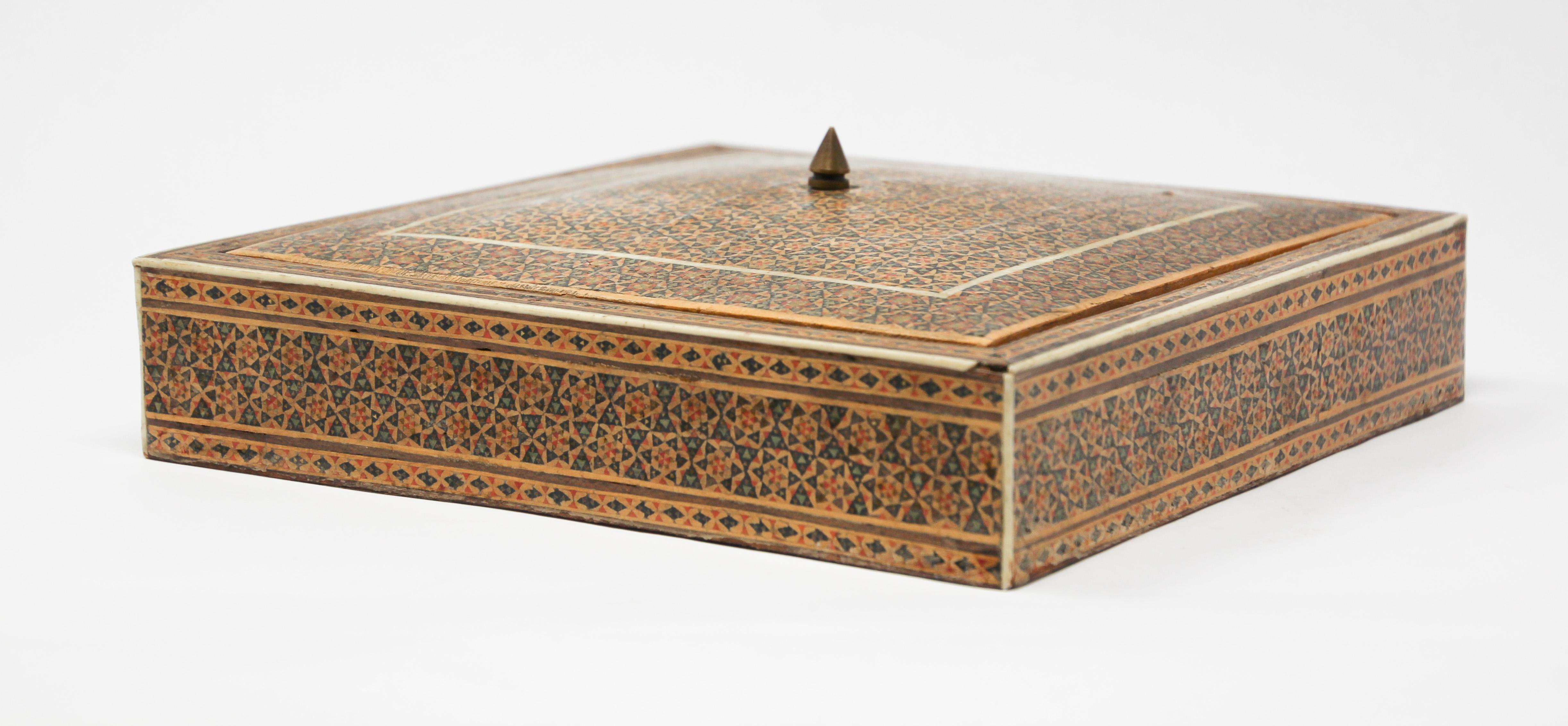 Middle Eastern Moorish micro mosaic inlaid jewelry box with lid.
Intricate inlaid Middle Eastern box with floral and geometric Islamic Moorish design in a rectangular form.
Moorish design mother of pearl inlay and marquetry, very fine artwork,