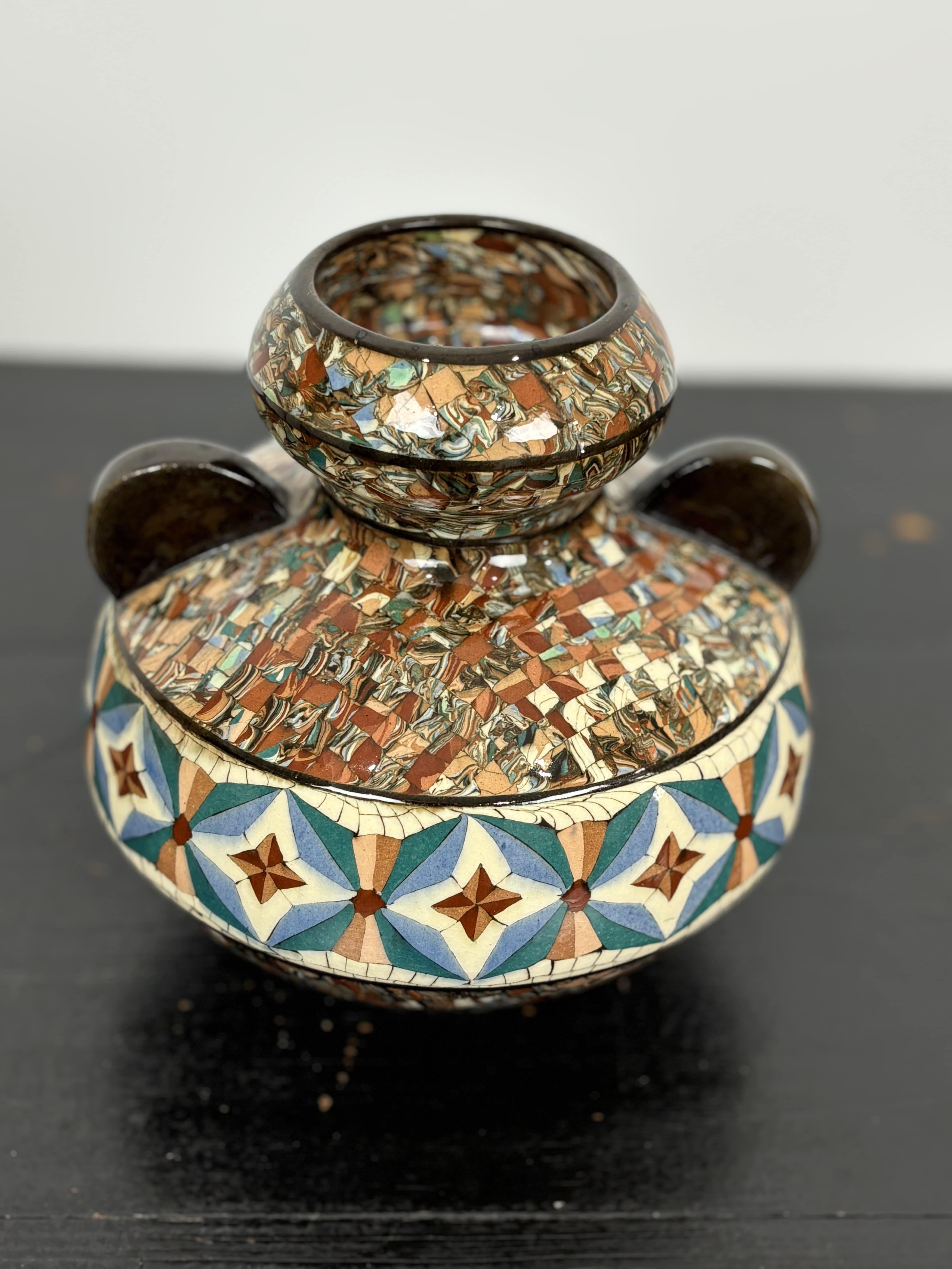 Gerbino Mosaic, Jean Gerbino (1876-1966). 
Beautiful eared ball vase in beautiful shades of brown, beige and blue/green, with a frieze mosaic pattern. 
Mosaic mixed earth technique. Very good condition. 
Signed intaglio on the base: Gerbino,