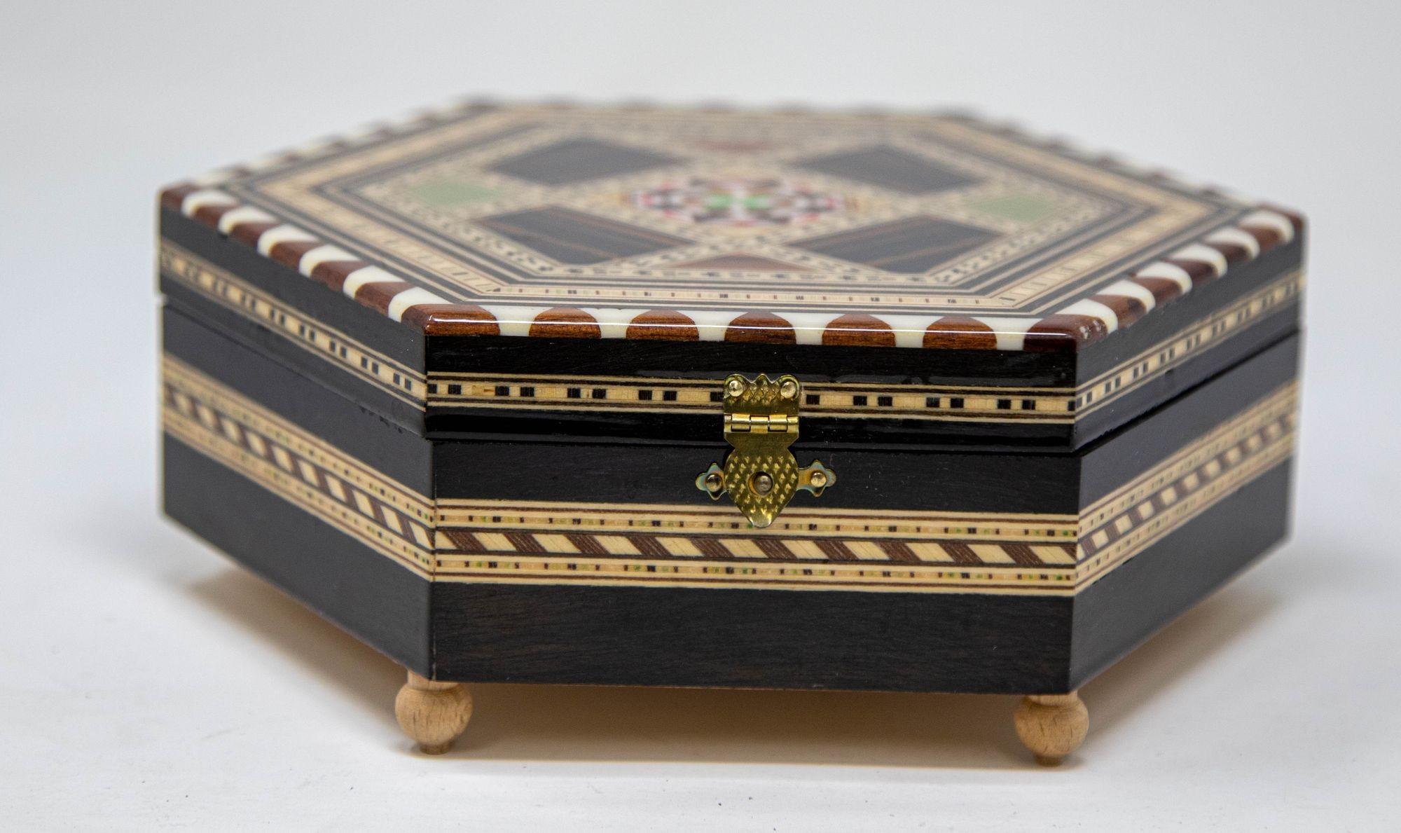 Vintage Mosaic Marquetry Moorish Octagonal Footed Music Box Granada Spain 1950.
Exquisite handcrafted vintage Middle Eastern Islamic style mosaic marquetry inlaid walnut wood footed music box.
Handcrafted in Spain in the Moorish Middle Eastern