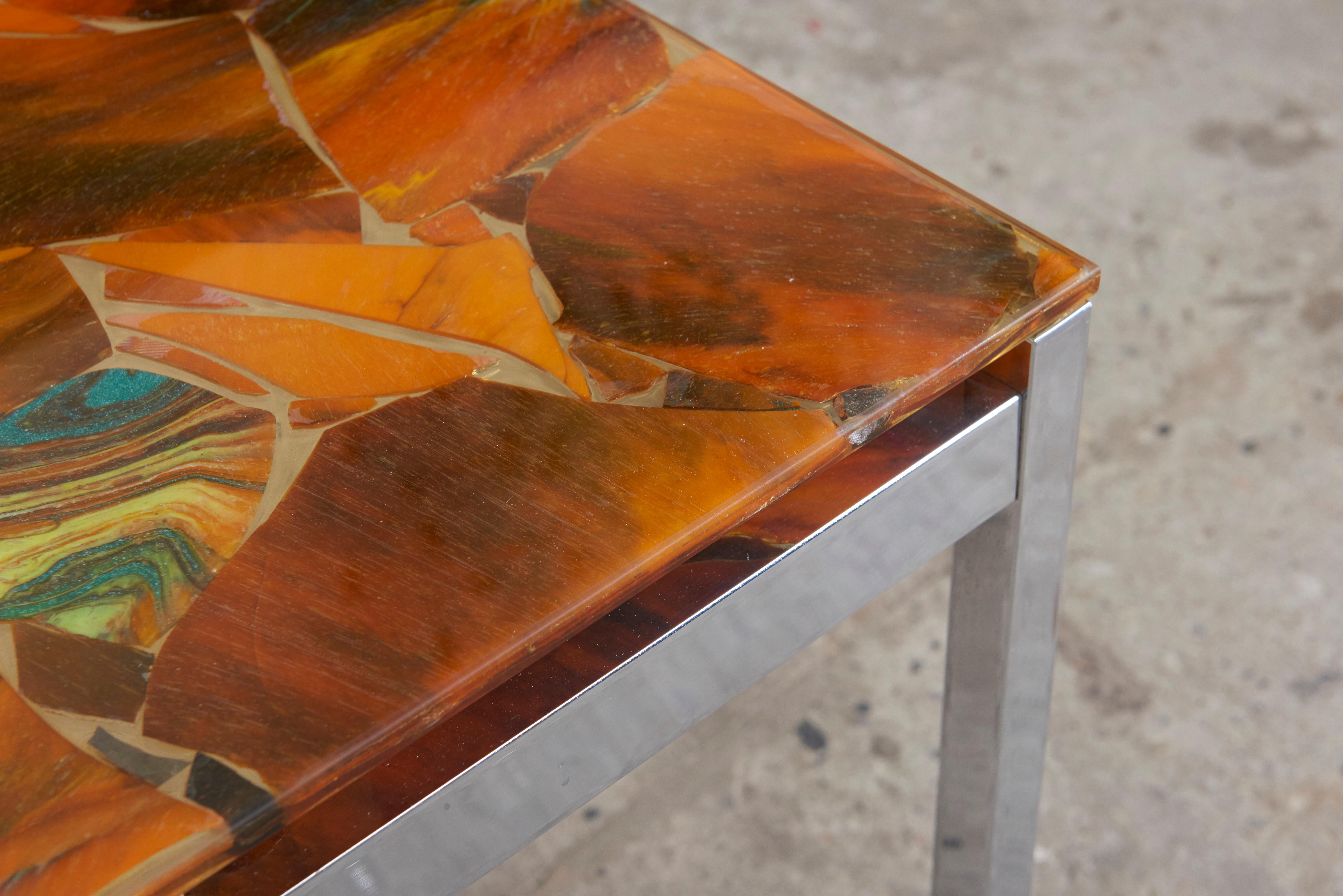 A beautiful decorative 1970s table with a rectangular metal chrome frame and a top of marbled glass in a mosaic pattern, which gives an airy translucence to the coffee table, very nice quality of this rare design.

This coffee or side table is an