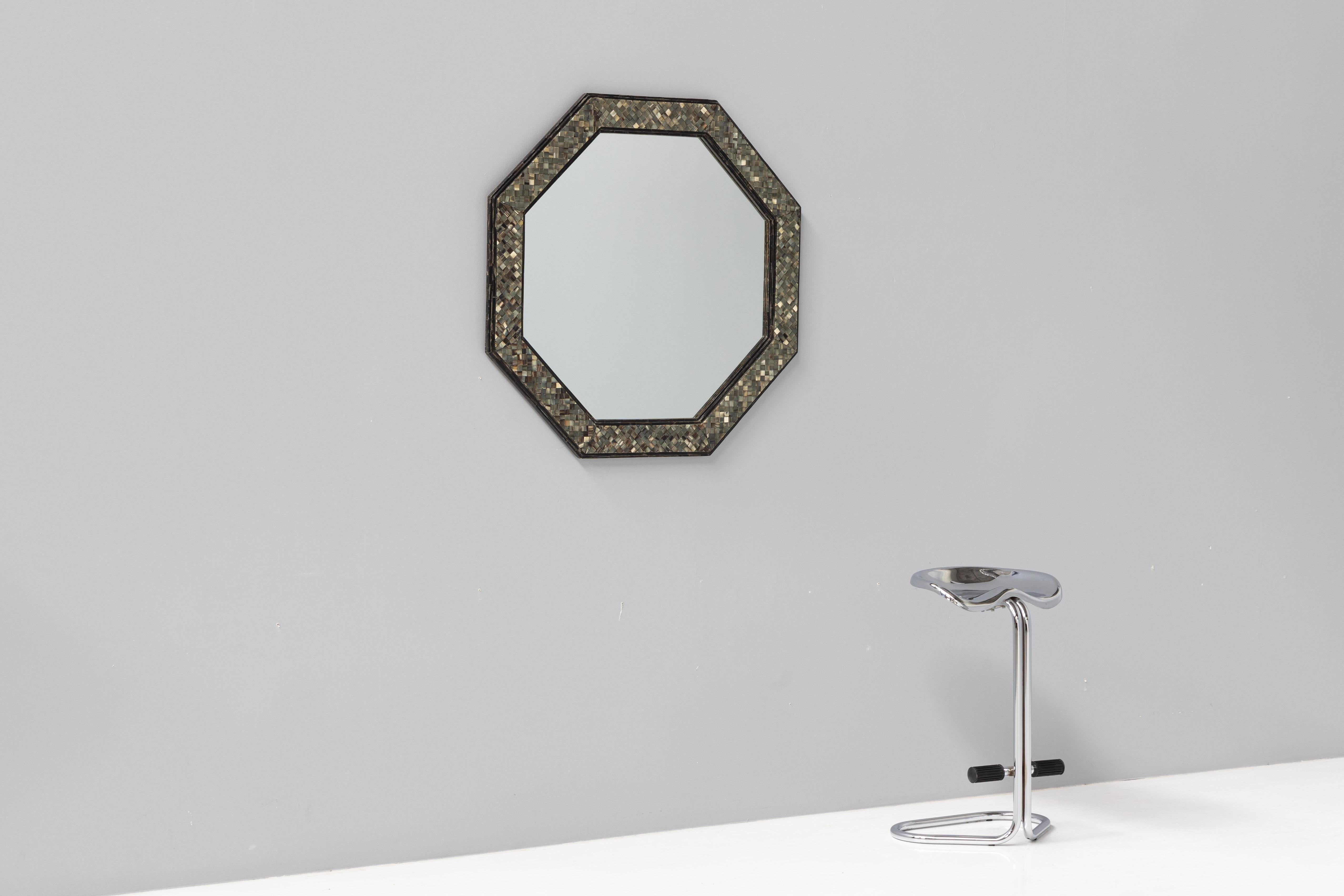 Octagonal mirror featuring a stunning horn mosaic inlay, crafted by Belgian designer Roger Vanhevel in the 1970s. This chic mirror embodies high-end elegance, perfect for luxurious and sophisticated decors. A rare find, it showcases Vanhevel's