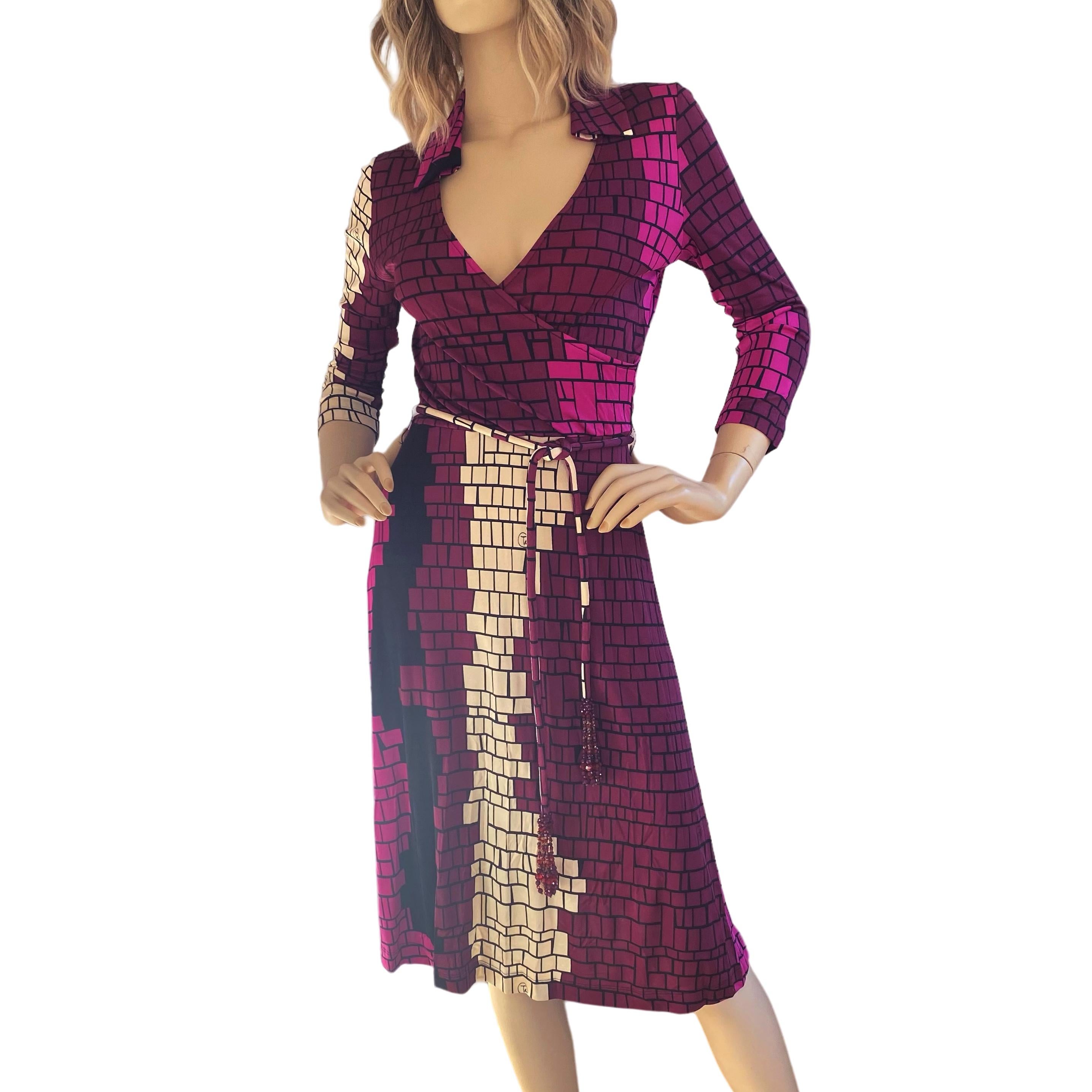 100% long-filament buttery silk jersey mock wrap dress. In original, signed 'Mosaic' print in cream, pink, burgundy, and black colors. 
Removable tasseled silk cord belt - use your own belt for a more daytime look.  
Pointed shirt collar. 3/4