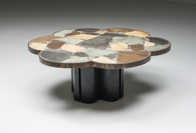 Italian design, Italy, Italian craftsmanship, Mosaic Stone flower shaped coffee table, Mid-Century Modern, Italy, 1950's

Italian coffee table with a flower-shaped mosaic stone table top made in the 1950s. The tabletop rests on a black base that