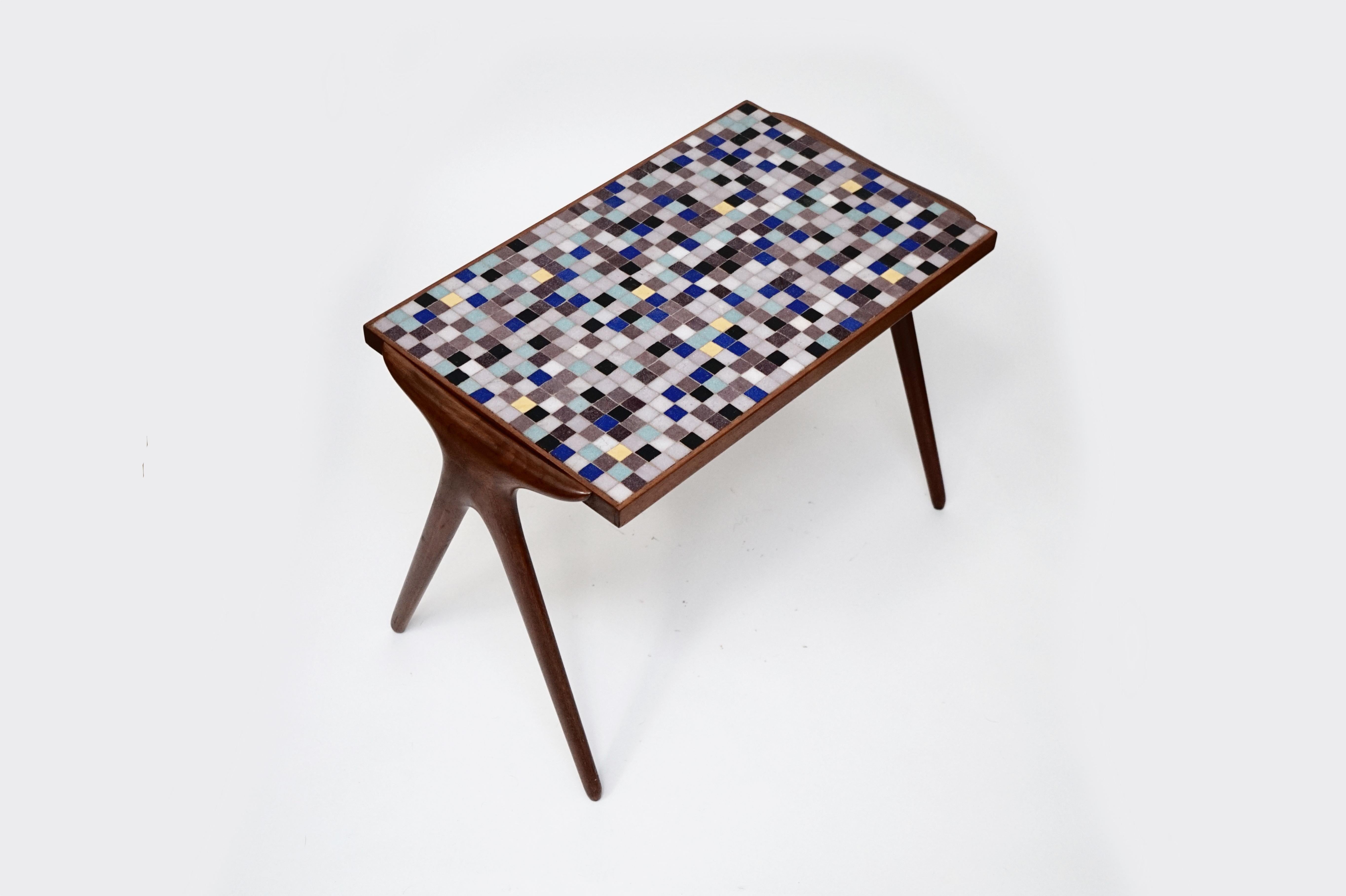 This rare gem of a side table is by Vladimir Kagan, during his early years with Hugo Dreyfuss featuring his highly-sought-after-by-collectors mosaic tiles on the table top and sculpted walnut frame for the table's body and legs. Produced in small