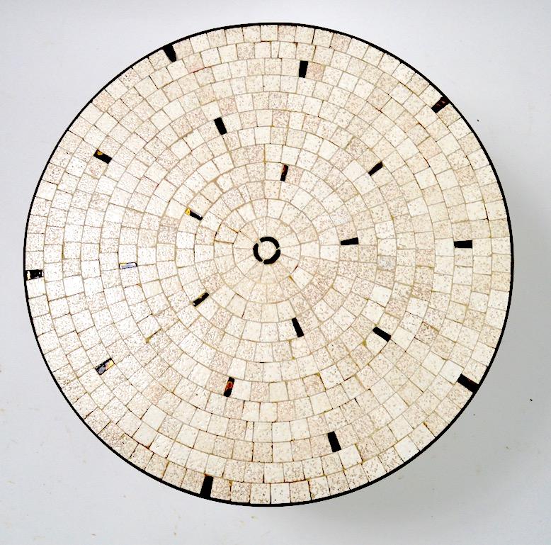 Nice diminutive mosaic tile-top, unusual to see these tables in this smaller scale. Sophisticated architectural design, thick brass bib surrounds the tile top, which rests on three solid cast brass legs, legs show significant cosmetic wear to