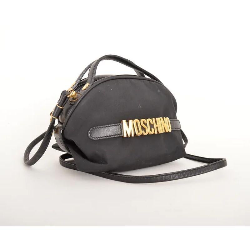 Chic Vintage 1990's Moschino black nylon mini bag featuring the iconic gold tone metal hardware letters and leather details.

Made in Italy !

Features:
Detacheable optional shoulder strap
x2 Top handles
Zip fasten closure
MOSCHINO