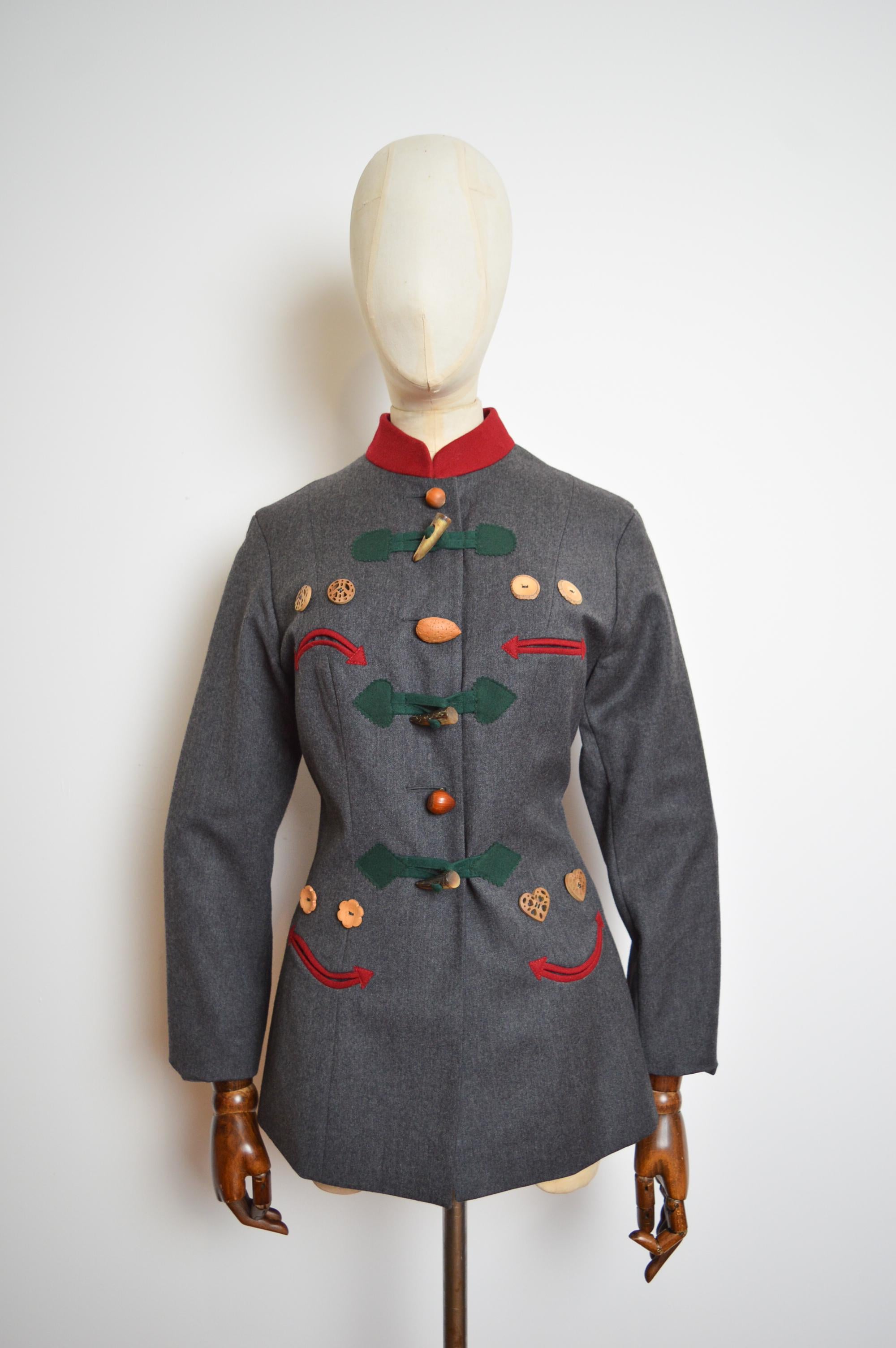 Superb Archival 1990’s Moschino Cheap & Chic ‘Nut’s about you’ tailored Blazer & Pant suit designed by the master of Italian tailoring Franco Moschino. 
MADE IN ITALY !
Crafted from Grey wool with hints of red and forest green, featuring ornately