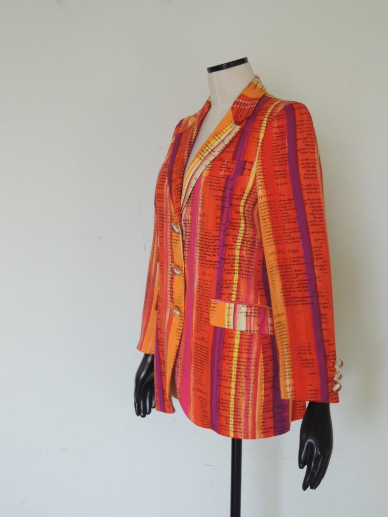 A vintage women's jacket from the 90s by Moschino for the Cheap and Chic line. In a rayon fabric that is woven in a way that it feels like linen and has watercolor inspired stripes in hues of oranges, purples, reds and white. This jacket has