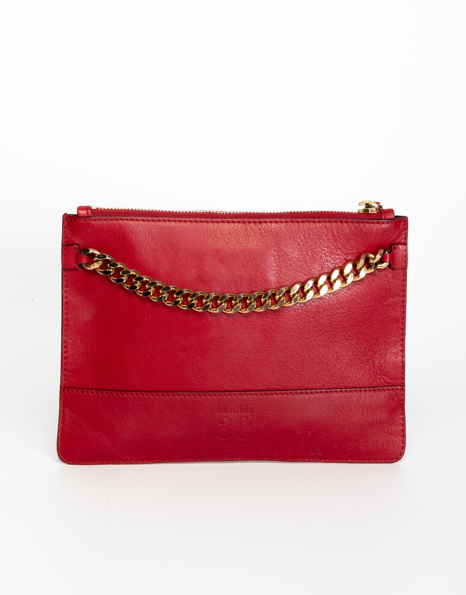 Moschino clutch made out of red leather featuring  gold tone hardware, moveable 