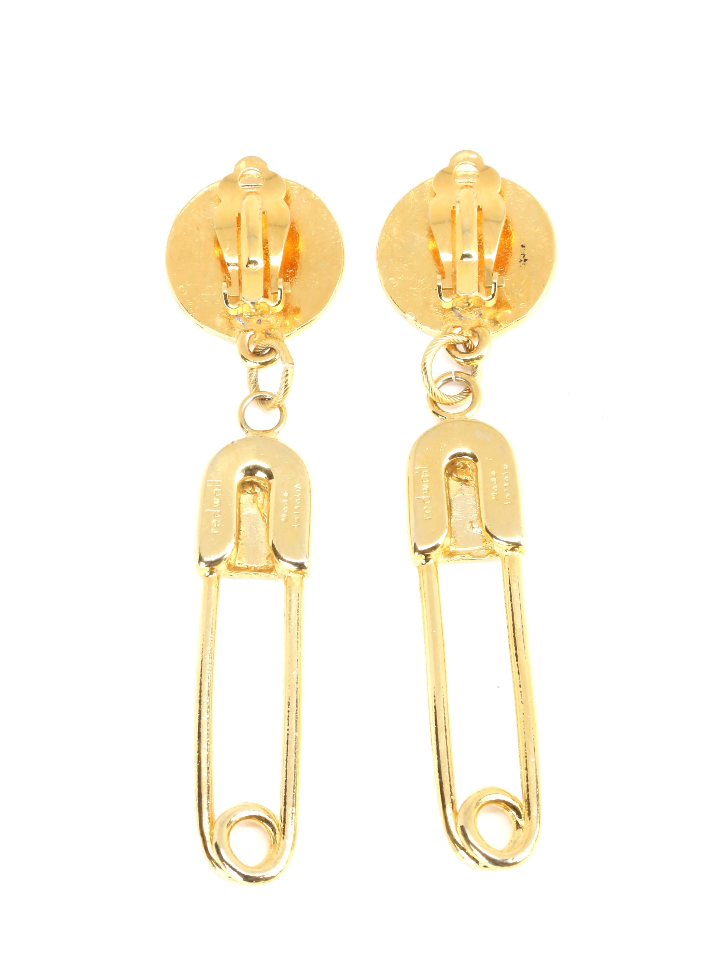 
Long gilt earrings with safety pin motif from Moschino dating to the early 1990's. Measure approximately 3.33