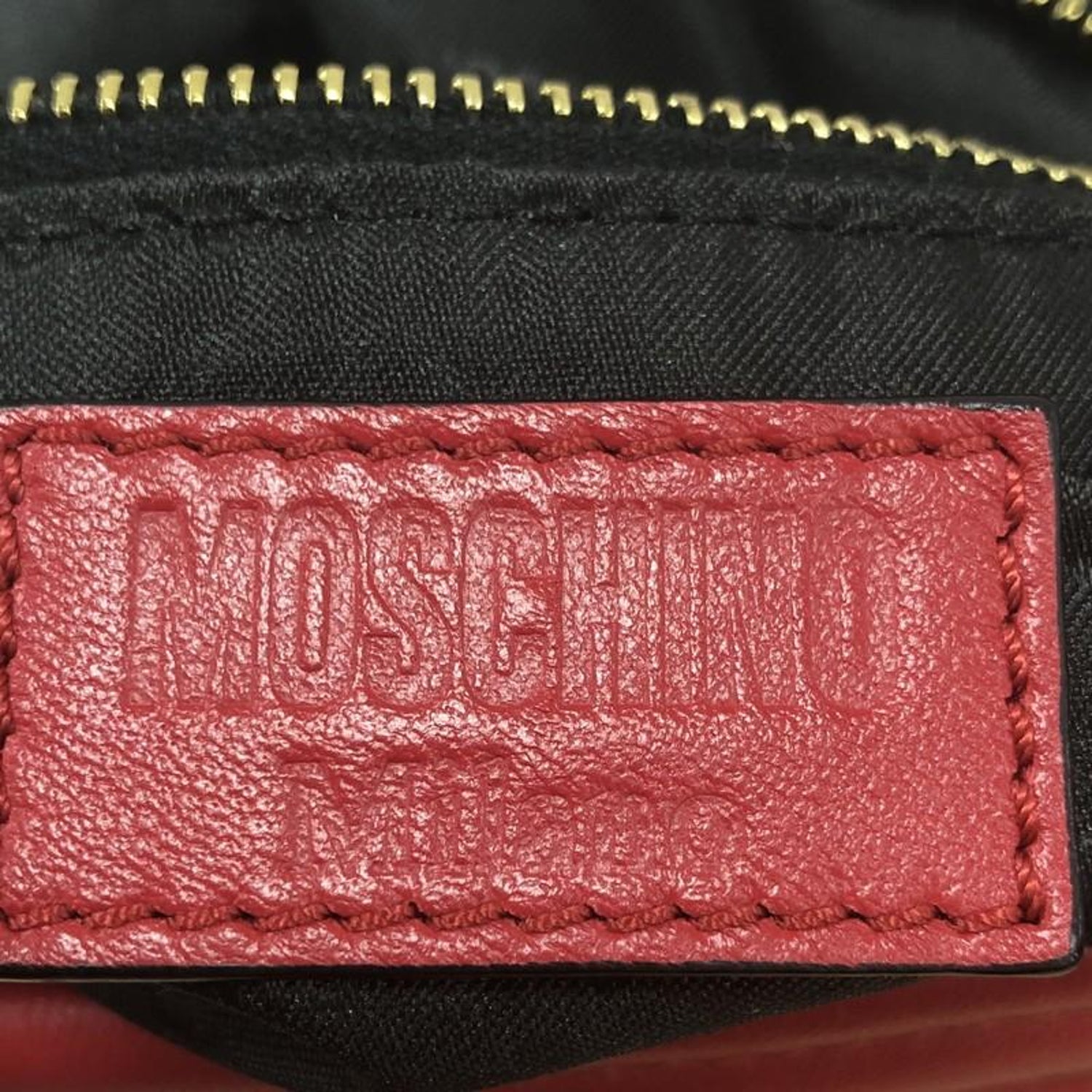 Pre-owned red Moschino Biker Bag photographed for a resale listing.