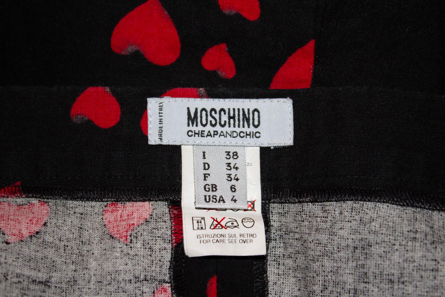 A fund and flirty skirt for Spring / Summer by Moschino, Cheap and Chic line.  The cotton skirt has a black background with a red heart print. It has a back central zip opening and is unlined.
Made in Italy , Size UK 6
Measurements:  waist 27'',