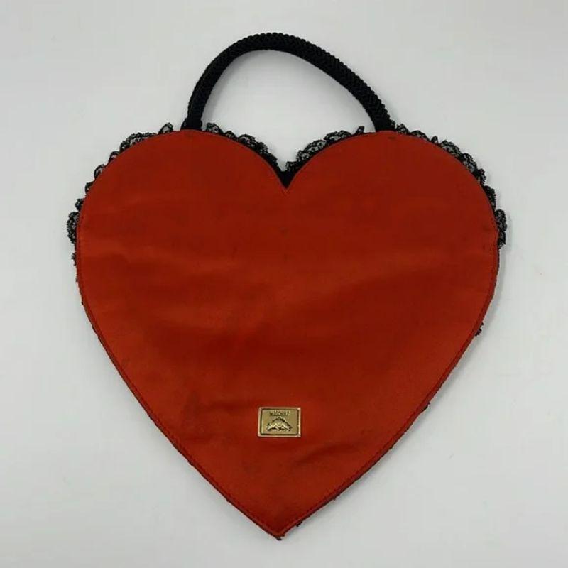 Moschino black lace red satin heart bag

Be retro cool wearing this vintage black lace and red satin hear shaped bag by Moschino!

Measurements:
Across front - 10 in.
Top to bottom - 9 in.
Strap Drop - 4 in.
Made in Italy

Note: The back side of
