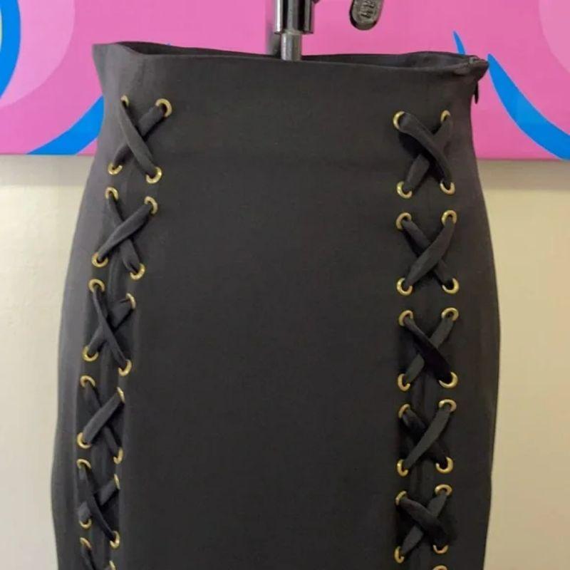 Moschino black lace up midi a line skirt

Be sustainably chic wearing this vintage Moschino Cheap and Chic skirt Pair with black turtleneck sweater, tights and ankle boots for a finished Fall look.
Brand runs small, see measurmenets.

Size 6
Across