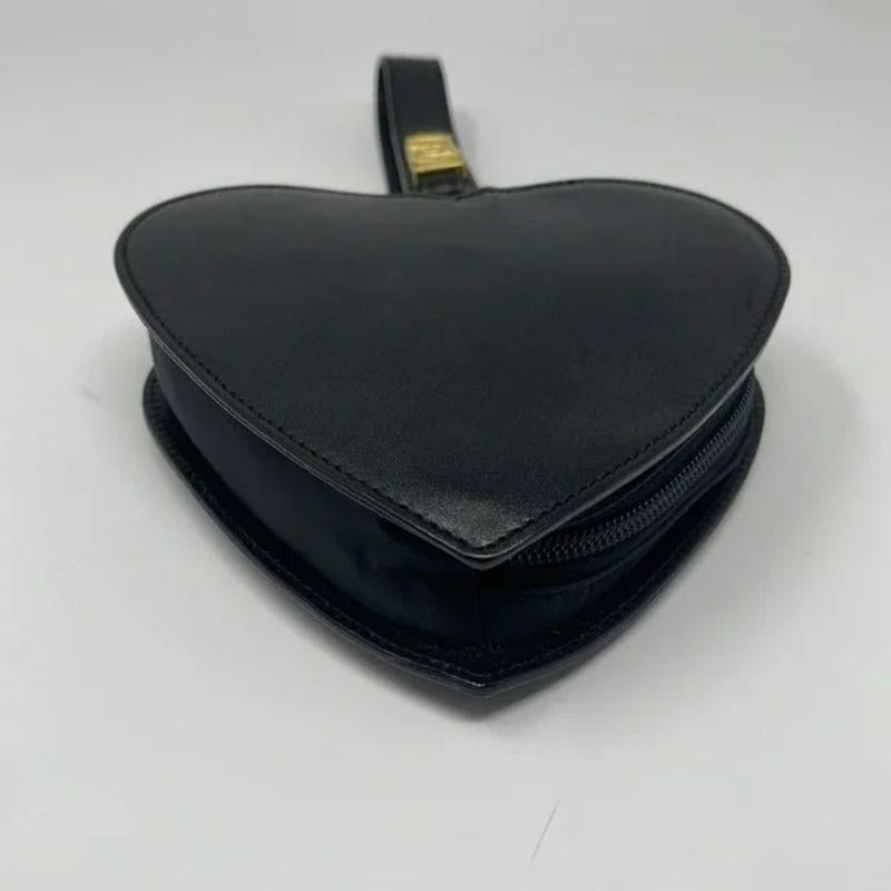 Moschino black leather heart wristlet mini bag vintage

Be retro cool wearing this vintage black leather heart shaped bag by Moschino. Gold tone metal hardware. Clean inside. Light scratches. Inside coming unglues at handle a bit. No Dust Bag.