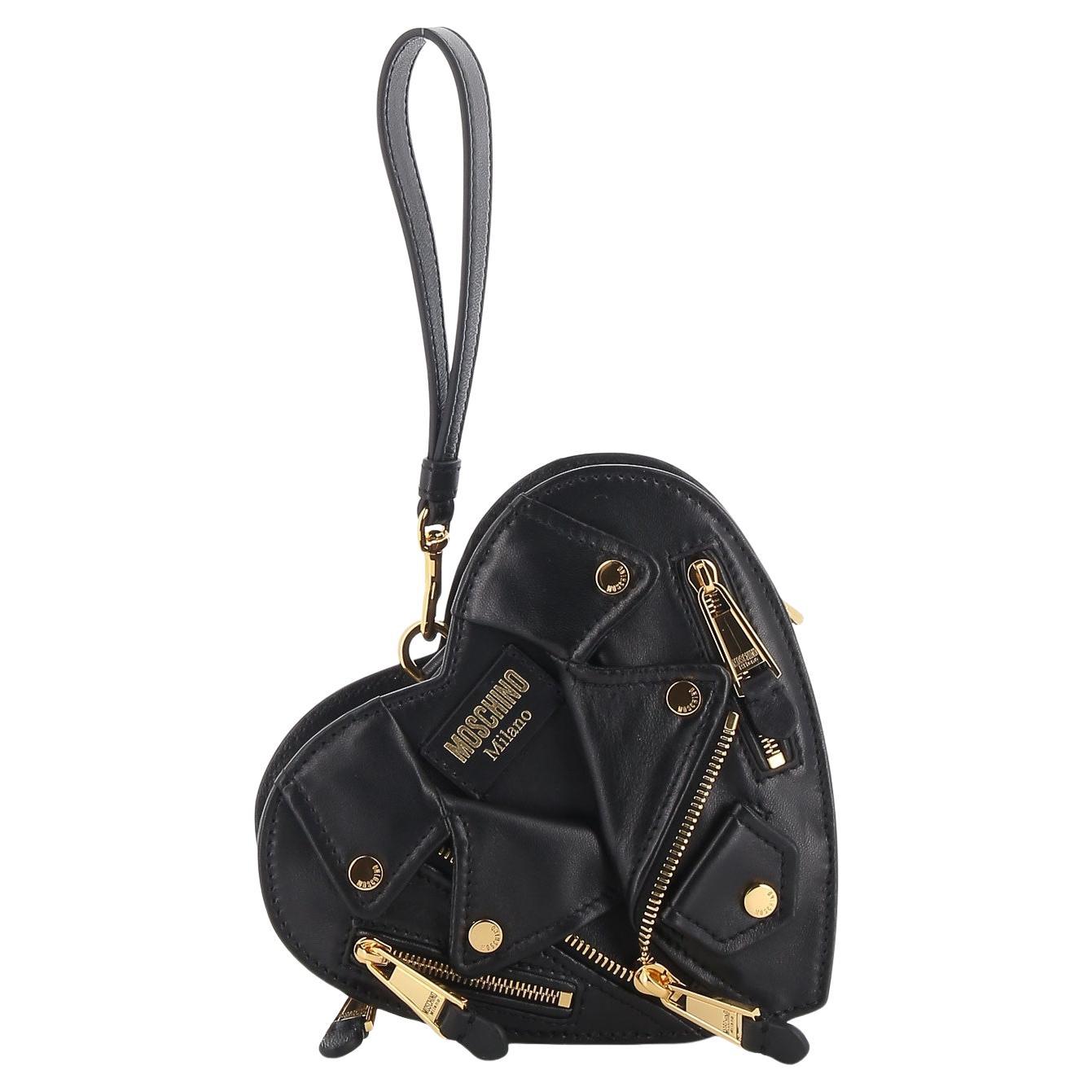 MOSCHINO BLACK LEATHER SILVER HEART BIKER BAG

This Moschino biker-inspired heart bag is made of smooth black leather with silver-tone hardware. Designed in the shape of a heart, it features moto jacket-inspired details, including a front zip