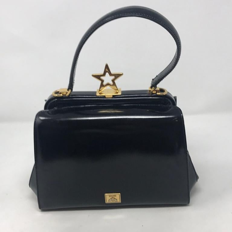 Moschino black polished leather star bag vintage

Museum quality Moschino vintage bag made of high polished leather with gold tone hardware.  Condition is average with surface scratches all over leather and hardware and due to improper storage 8