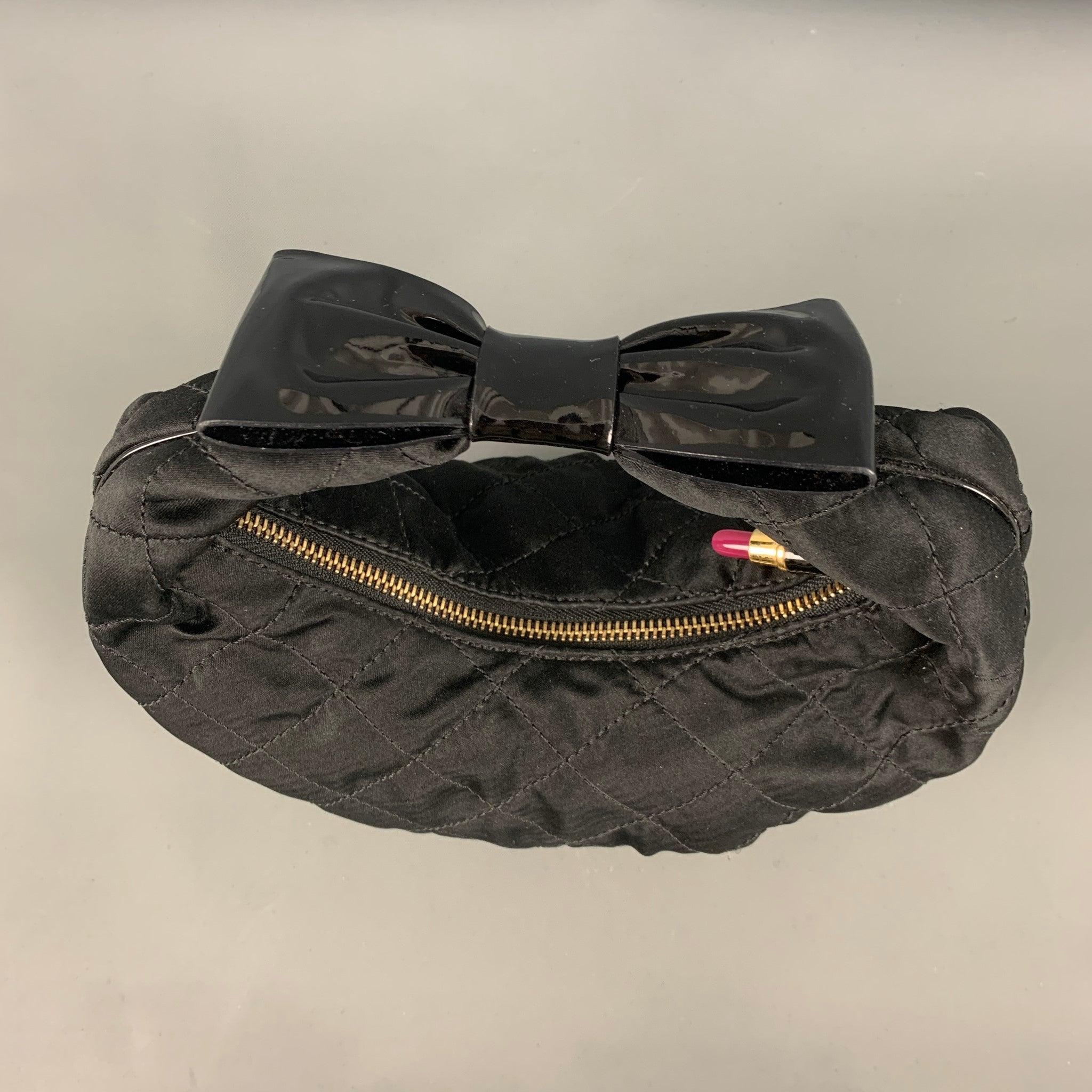 MOSCHINO Cheap and Chic bag comes in a black quilted woven material featuring a bow detail at the handle, inner pocket, and a zipper closure. Made in Italy. Very Good Pre-Owned Condition. Minor signs of wear. 

Measurements: 
  Length: 10.5 inches