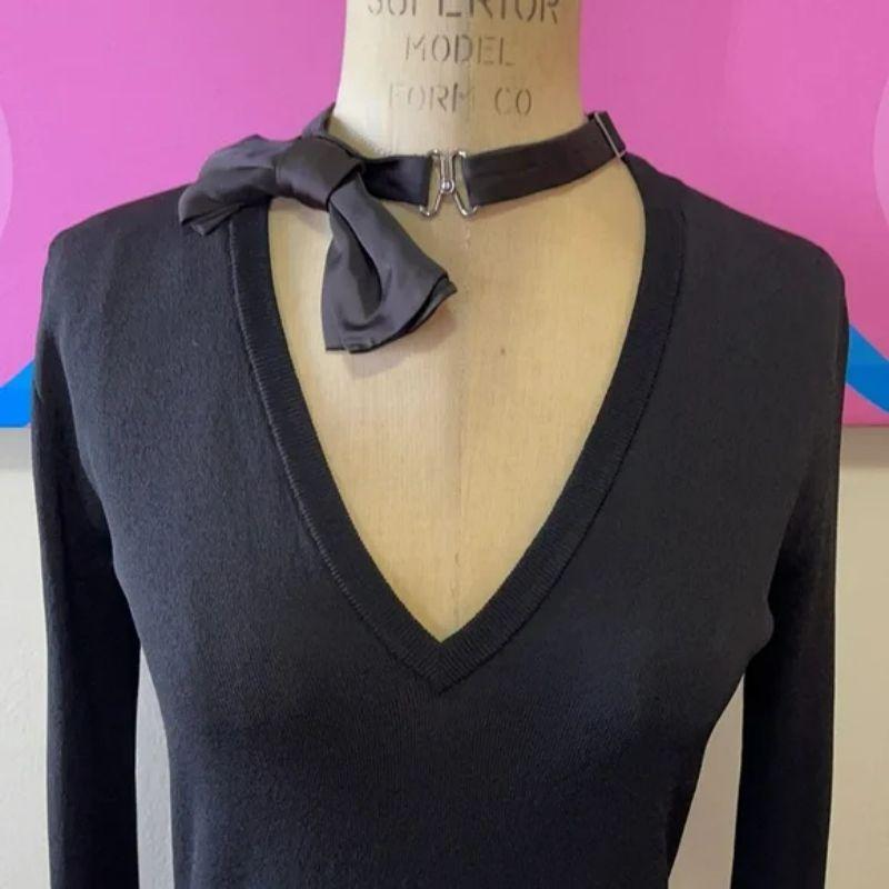 Moschino black v neck bow tie tuxedo sweater

Moschino makes special occasion cool and sexy with this bow tie neck sweater. Perfect for date night with black skinny pants or pencil skirt and ankle boots for a finished look. Thin enough to wear under