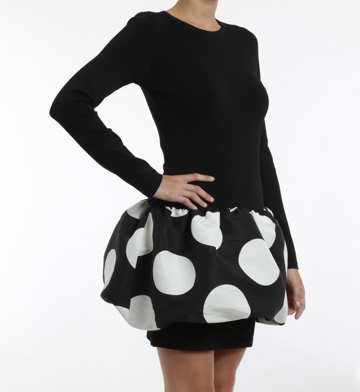 Embrace a chic yet playful aesthetic with the Moschino Boutique Black & White Polka Dot Bubble Skirt Long-Sleeve Dress. This striking mini dress features a sleek black long-sleeve silhouette that exudes sophistication, while the unique bubble skirt