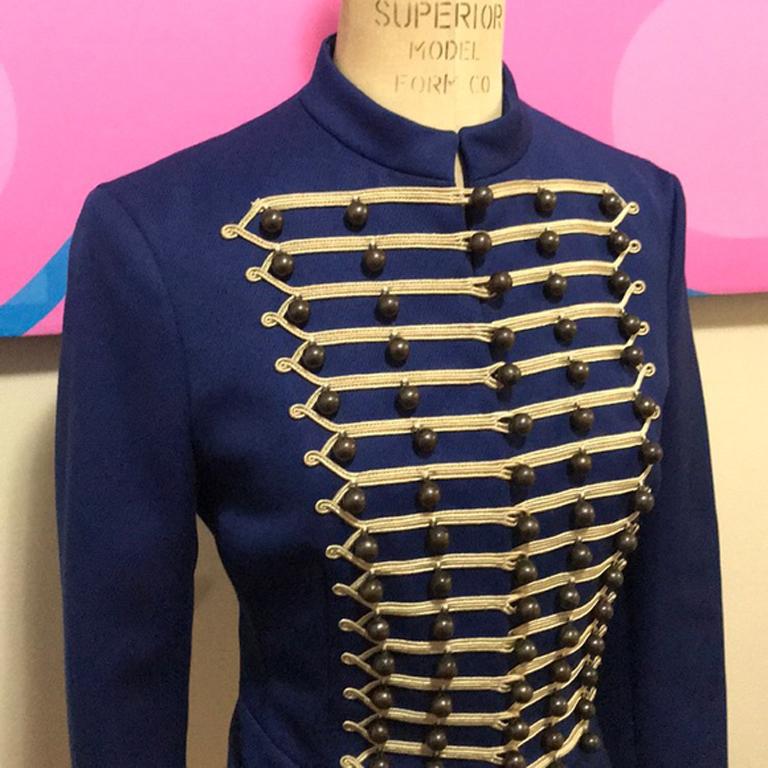 Moschino blue wool military band jacket

Be retro cool this fall wearing this military jacket ! Pair with black skinny pants and knee high boots for a finished look. Discoloration on inside lining at armpits and brand tag and collar. Gold braid