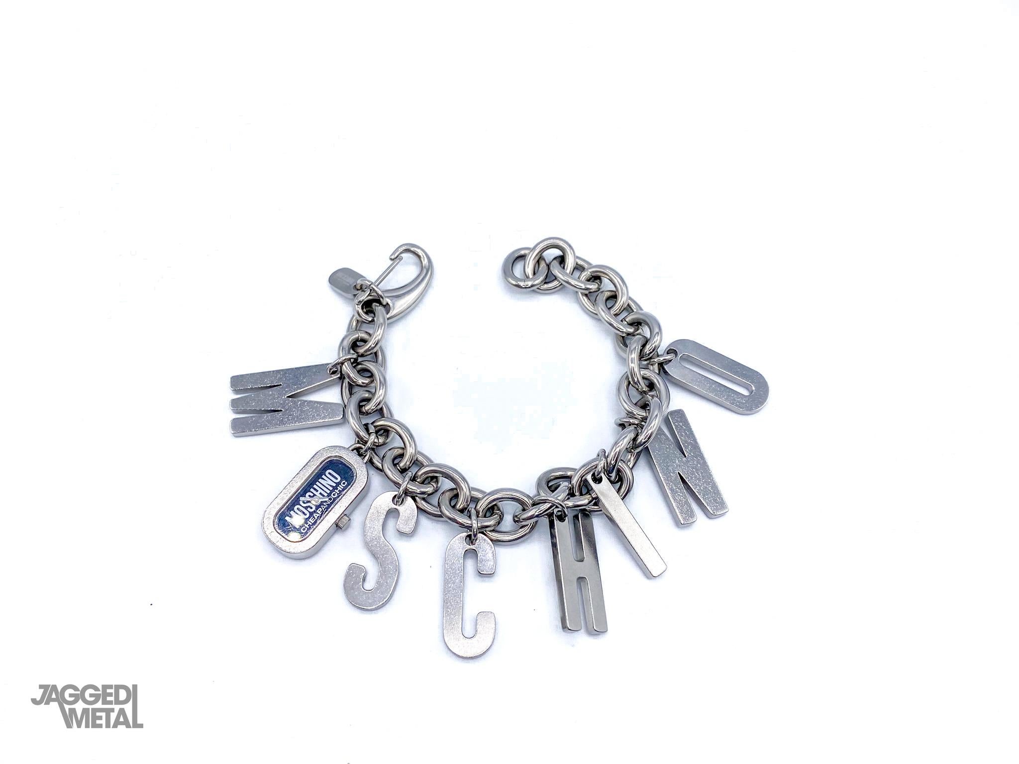Moschino 1990s Vintage Charm Bracelet

Amazing statement piece from the iconic house of Moschino. Doubles up as a bracelet and watch.

Detail
-Made in the early 2000s
-Cast from stainless steel metal
-8 charms which spell out the letters