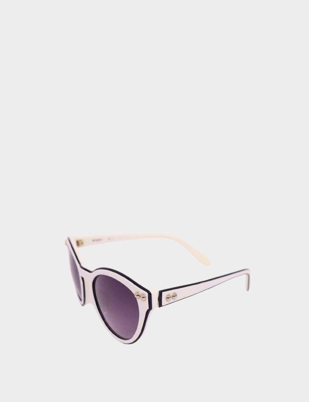 Make a playful style statement with these Moschino cat-eye sunglasses. Featuring a bold ivory white acetate frame with sleek black trim and gradient lenses, these sunglasses blend retro glamour with Moschino's signature whimsical attitude. Gold-tone