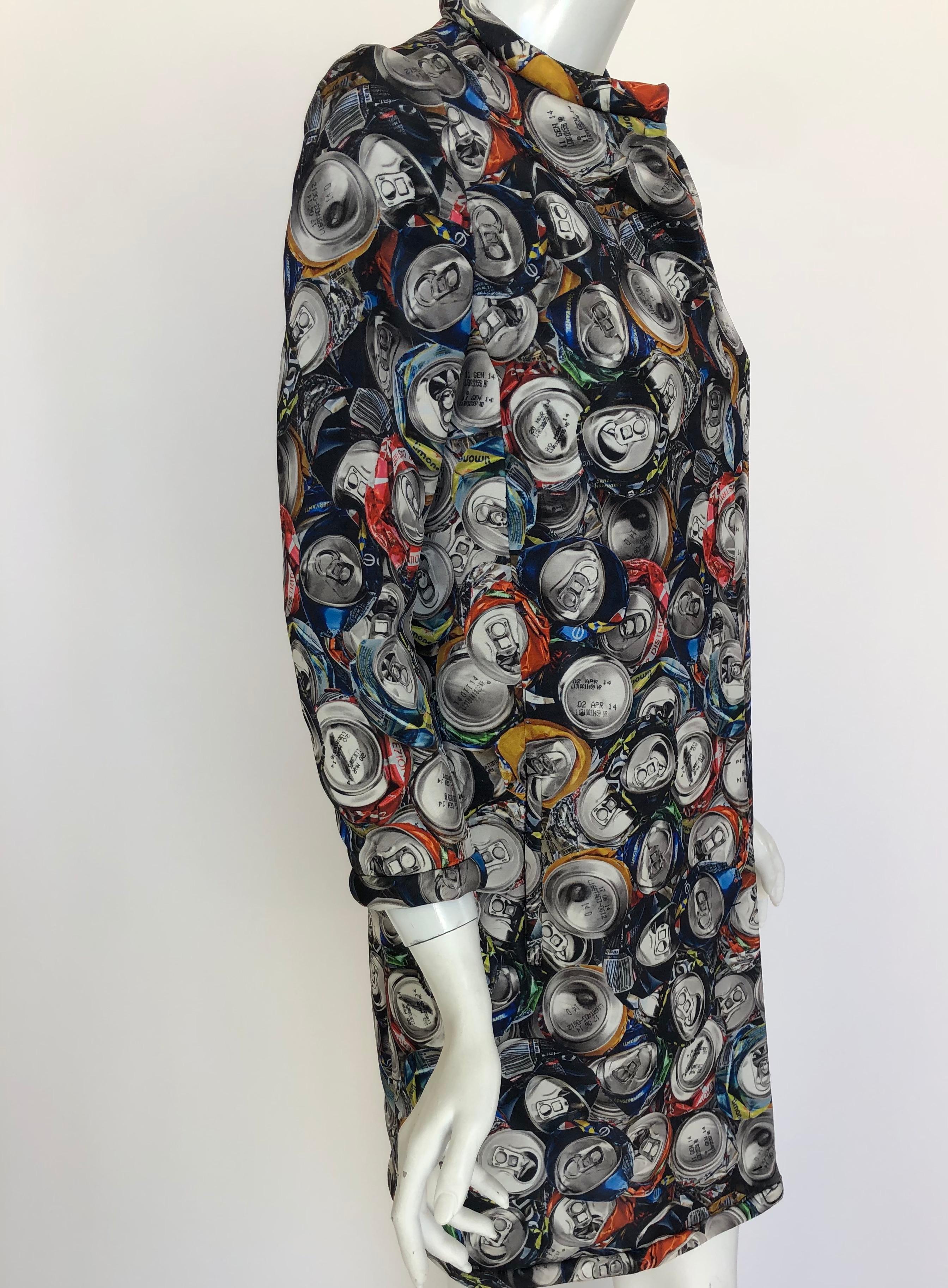 This is a long sleeved rolled collar coat, with hidden snaps, and an all over soda can print pattern. 