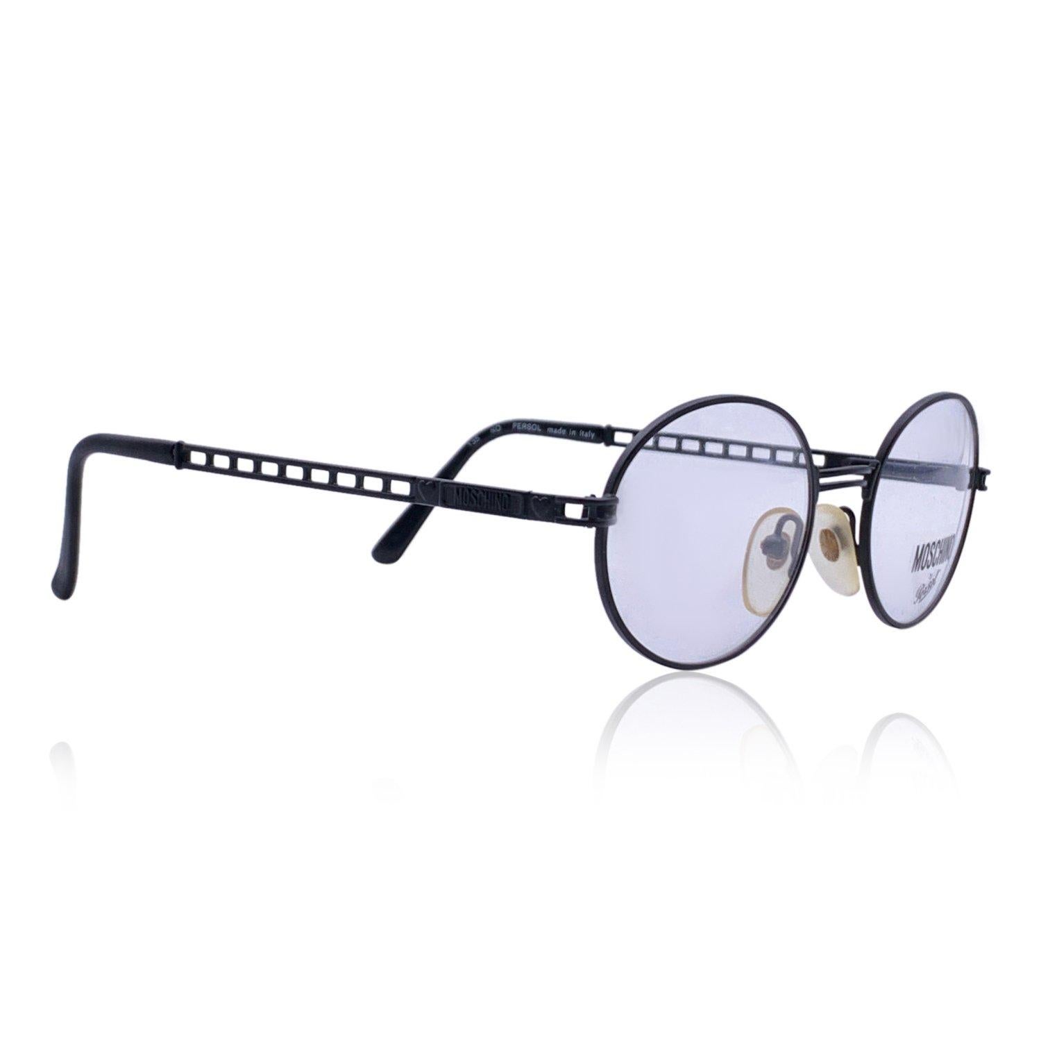 Black metal eyeglasses by Moschino by Persol. Oval design. Model: MM525. 48/18 - 130 mm - logo on temples - clear demo lens. Made in Italy Details MATERIAL: Metal COLOR: Black MODEL: MM525 GENDER: Woman COUNTRY OF MANUFACTURE: Italy ORIGINAL CASE?: