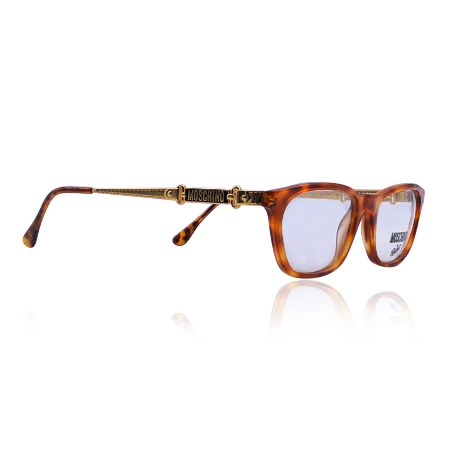 Brown acetate eyeglasses by Moschino by Persol. Rectangle design. Model: M55. 54/19 - 140 mm - logo on temples - clear demo lens, brown tortoise front with gold metal ear stems Details MATERIAL: Acetate COLOR: Brown MODEL: M55 GENDER: Woman COUNTRY