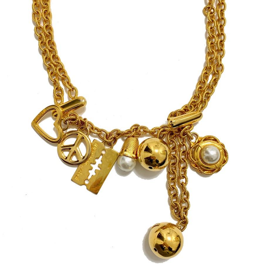 Vintage MOSCHINO by Redwall chain necklace-belt in gilt metal set with charms: a heart, peace sign, razor, thimble with a pearly fancy pearl, a gold balloon and a flower with a fancy pearly pearl. The MOSCHINO brand is engraved on the golden