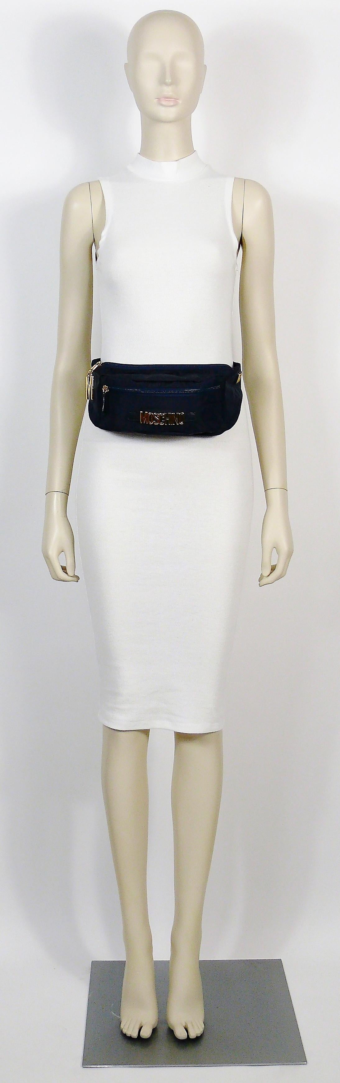 MOSCHINO by REDWALL vintage navy blue fanny pack.

Thick nylon body with gold toned hardware.

Two zippered pockets.

One size fits all.
Adjustable strap length.

Marked MOSCHINO REDWALL Made in Italy.
Serial number 461005.
MOSCHINO BAGS black