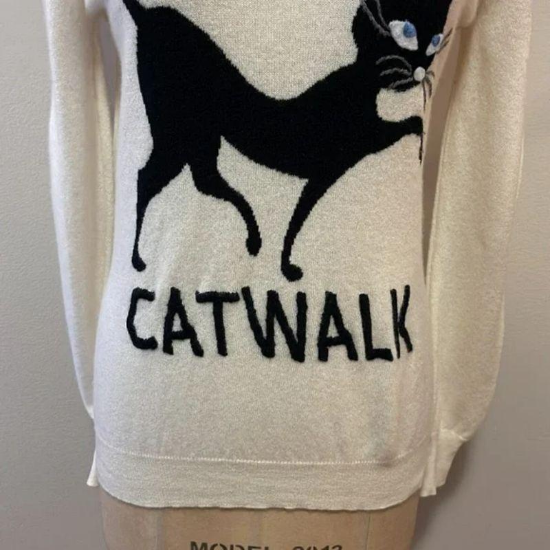 Moschino catwalk ivory cashmere sweater black cat

Take on the cold in style wearing this adorable Catwalk sweater by Moschino. Made of 100% Cashmere. Pair with white jeans or black pencil pants and boots for a finished look. Tiny spot on