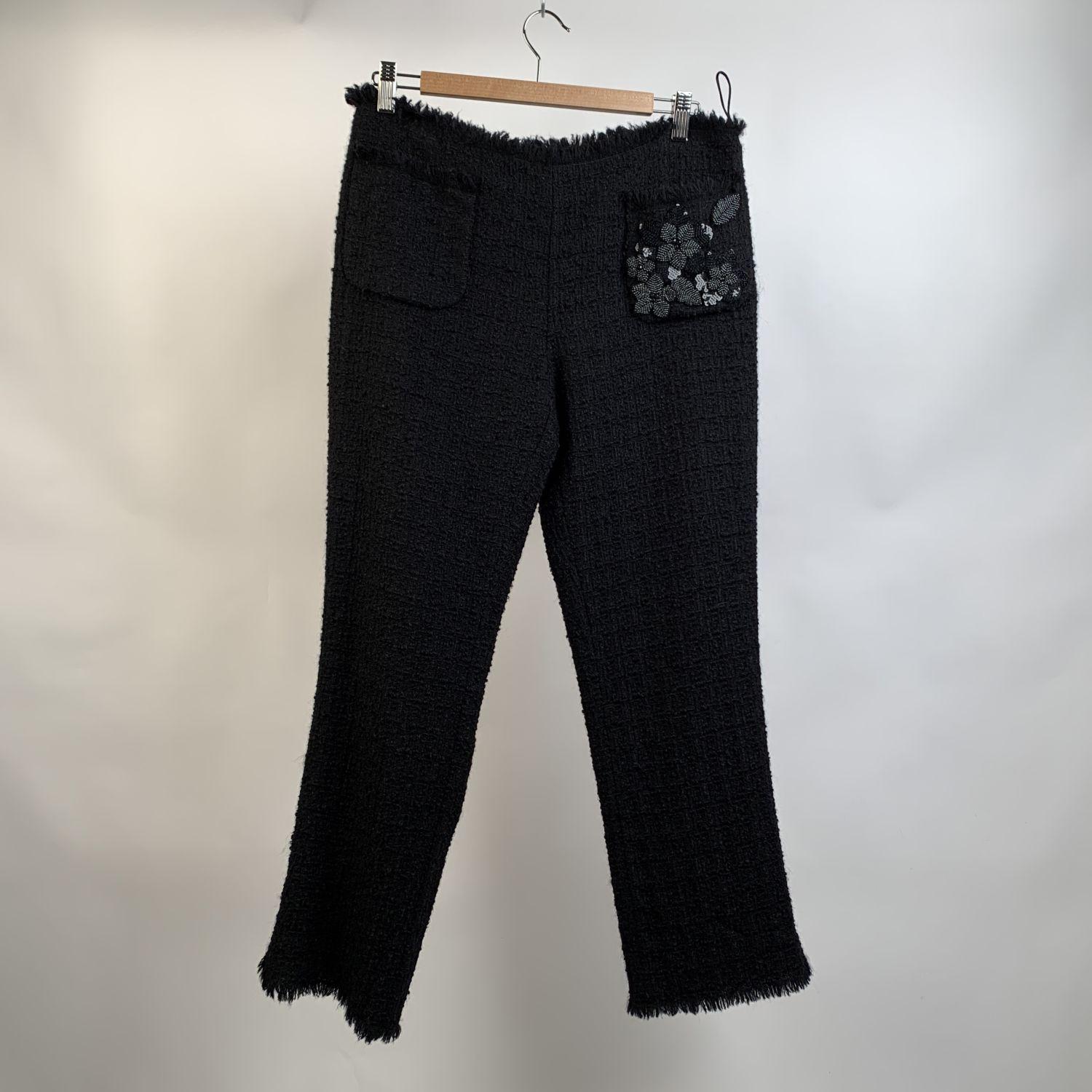 Moschino Cheap & Chic black bouclé pants trousers. They feature front patch pockets and one is embellished with beads. Side zip pocket. Frayed waist and hem. Composition: 97% virgin wool, 3% other fibres. Size: 44 IT, 40 D, 13 GB, 10 USA (it should
