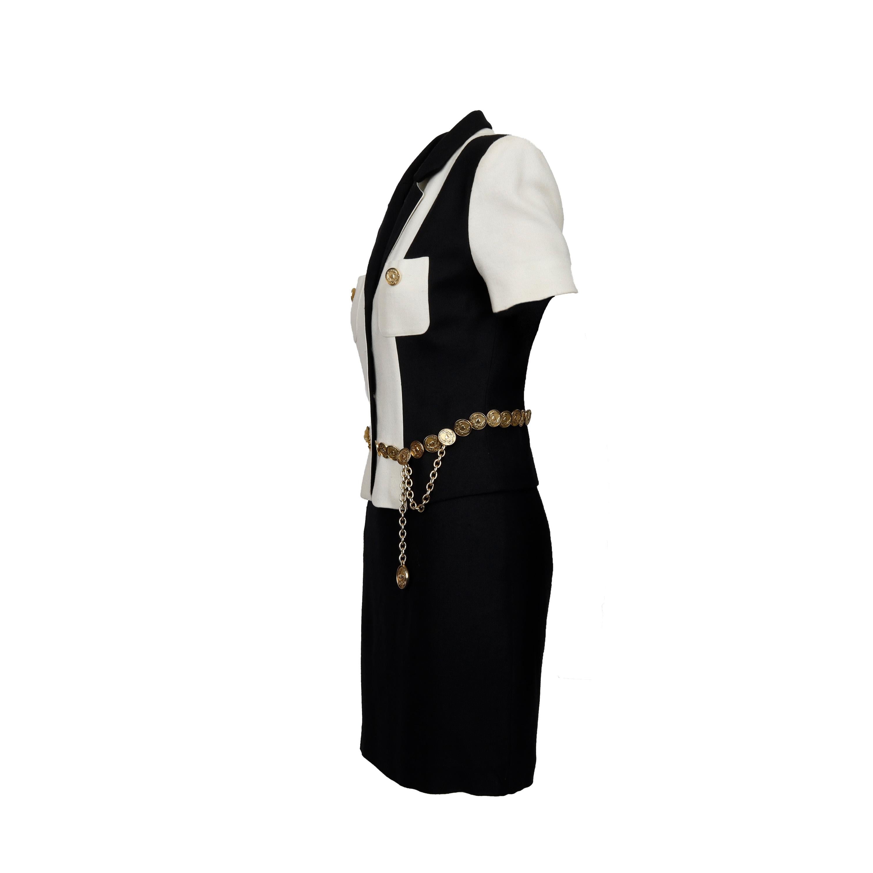 This Moschino Cheap and Chic black and white jacket and skirt set features an eye-catching gold-colored metal coin belt to accentuate the waist and add a touch of vintage to the classic 80s silhouette. Double pockets with the same coin buttons on