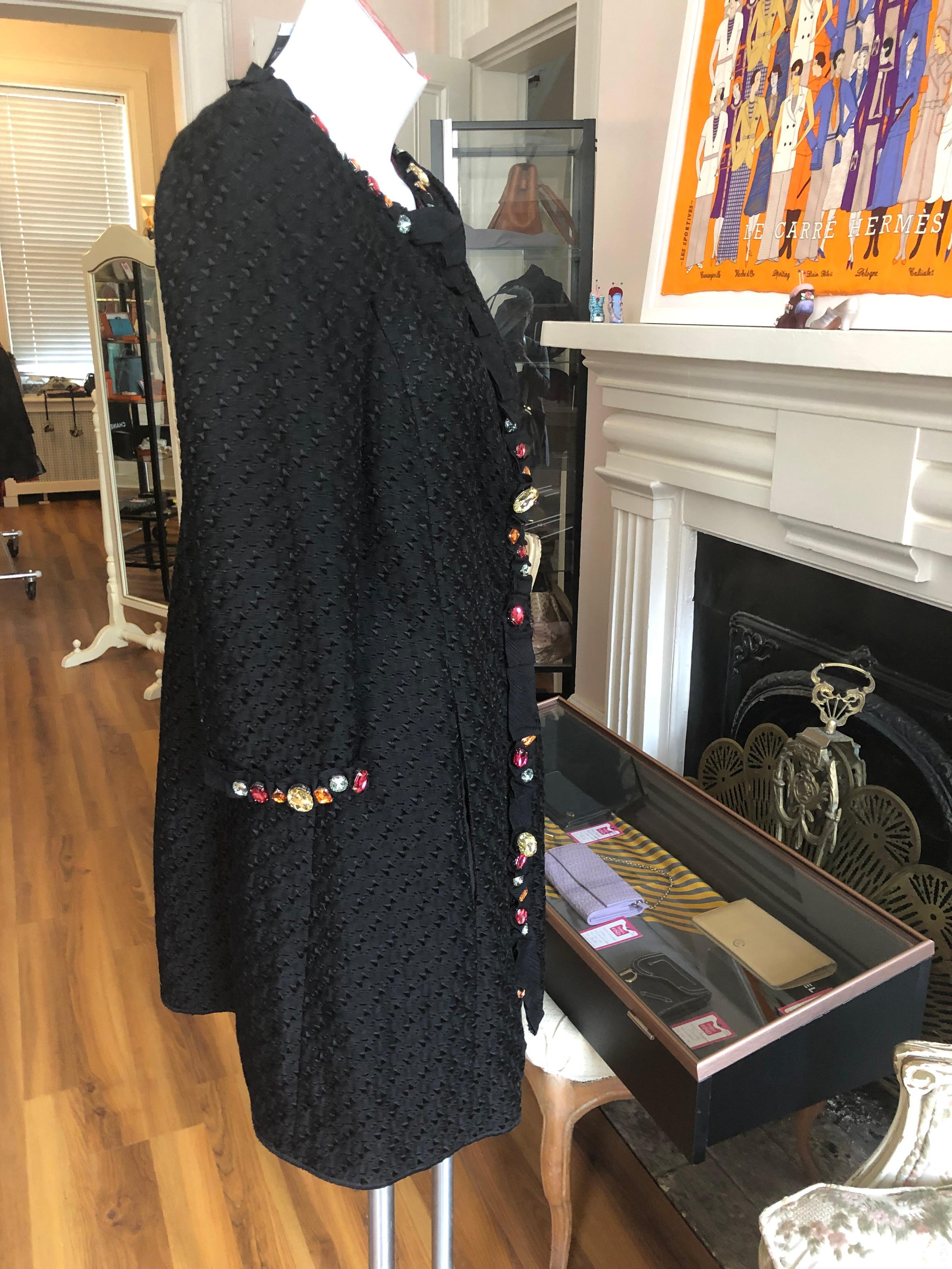 Fabulous Moschino Cheap and Chic coat in weaved cotton which forms a pattern. This coat is embellished with colored rhinestones; has wonderful inside seams; two front pockets and pleated accents.

It could be worn as both a coat and a dress.