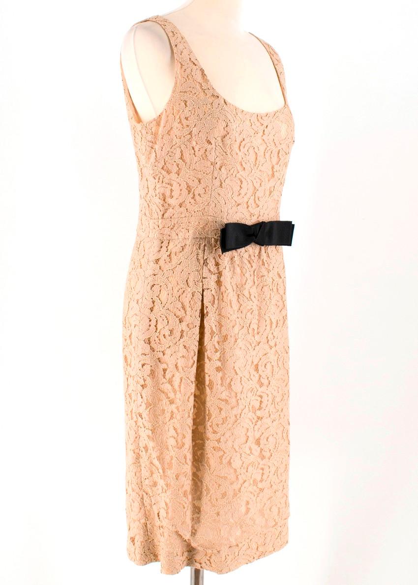 Moschino Cheap and Chic Tan Lace and Bow Dress
 
 - Tan A-Line Dress
 - Sleeveless, round neck
 - Slimmed waist
 - Black bow feature at center front
 - Fully lined
 - Zip fastening closure at back of dress
 
 Please note, these items are pre-owned