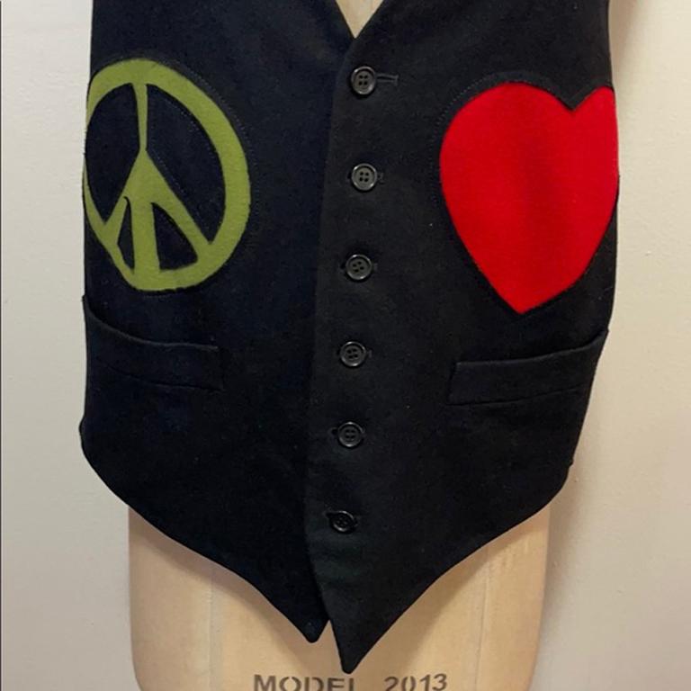 Moschino cheap & chic men's black wool heart vest

Be retro cool wearing this vintage Moschino vest with a red Heart, green Peace Sign and ivory Question Mark. Great for special occasion dressing and showing your sense of fun! Tiny spot on the