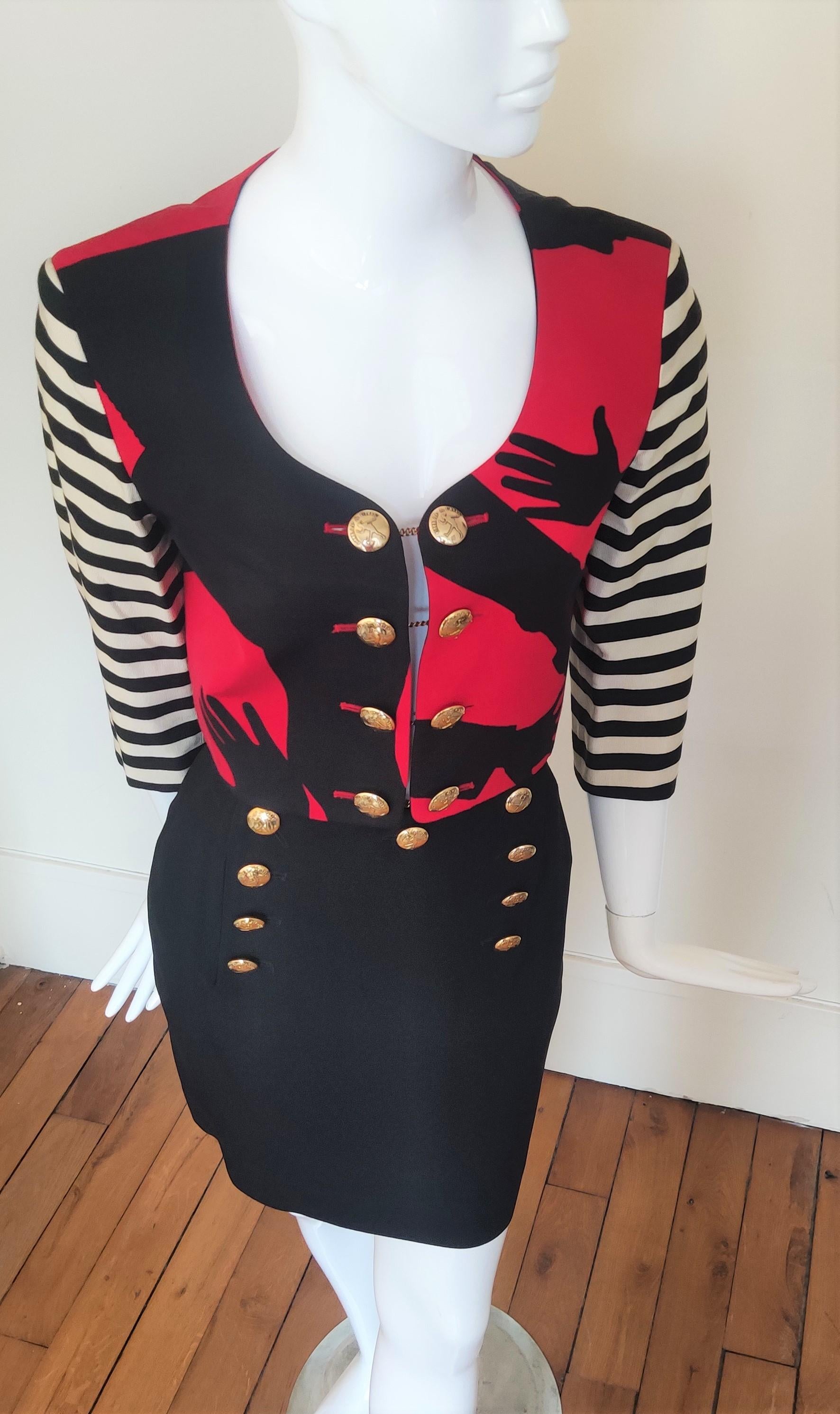 Vintage Moschino Cheap and Chic Olive Oyl (Popeye) silhouette print cropped jacket with red stripe sleeve and high waist silhouette print skirt.

Featuring eight cheap and chic good plated buttons connected by gold chains.
With shoulder
