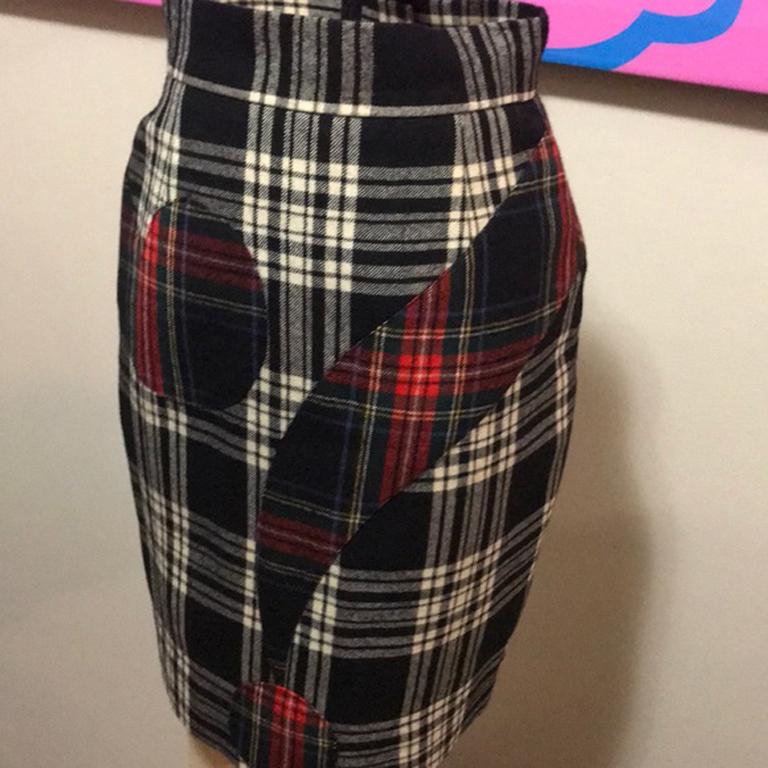 Moschino cheap chic question mark plaid skirt

Unique wool pencil skirt wit plaid on plaid and a big question mark ! Pair with a simple black turtleneck sweater and black tights and boots for a finished look. Brand runs small. 
Size