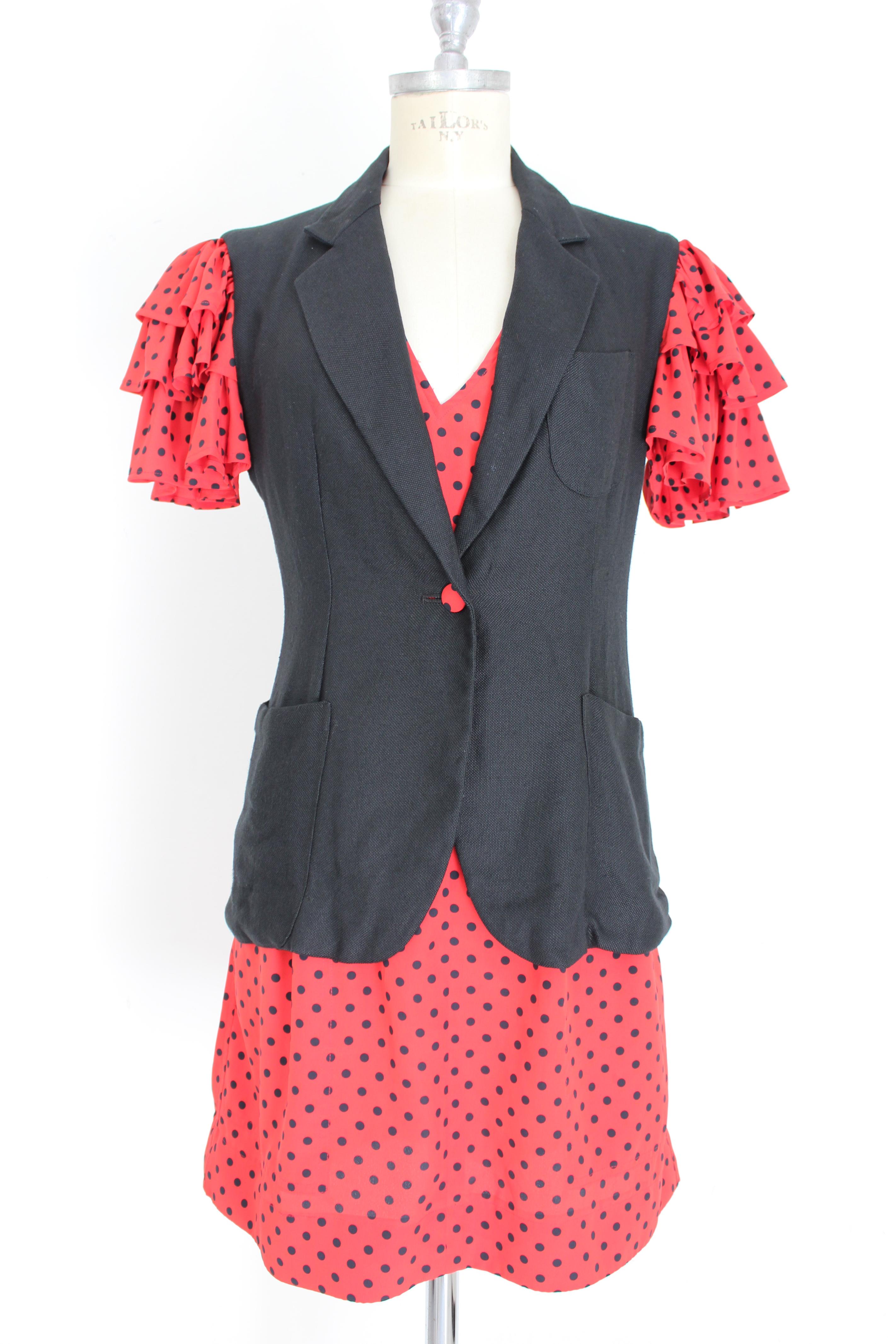 Moschino Cheap and Chic 90s vintage women's suit dress. Red and black polka dot dress and jacket. Short dress with American neckline, side pockets, zip closure on the back. 100% polyester fabric. Fitted jacket with flounced sleeves, 100% rayon