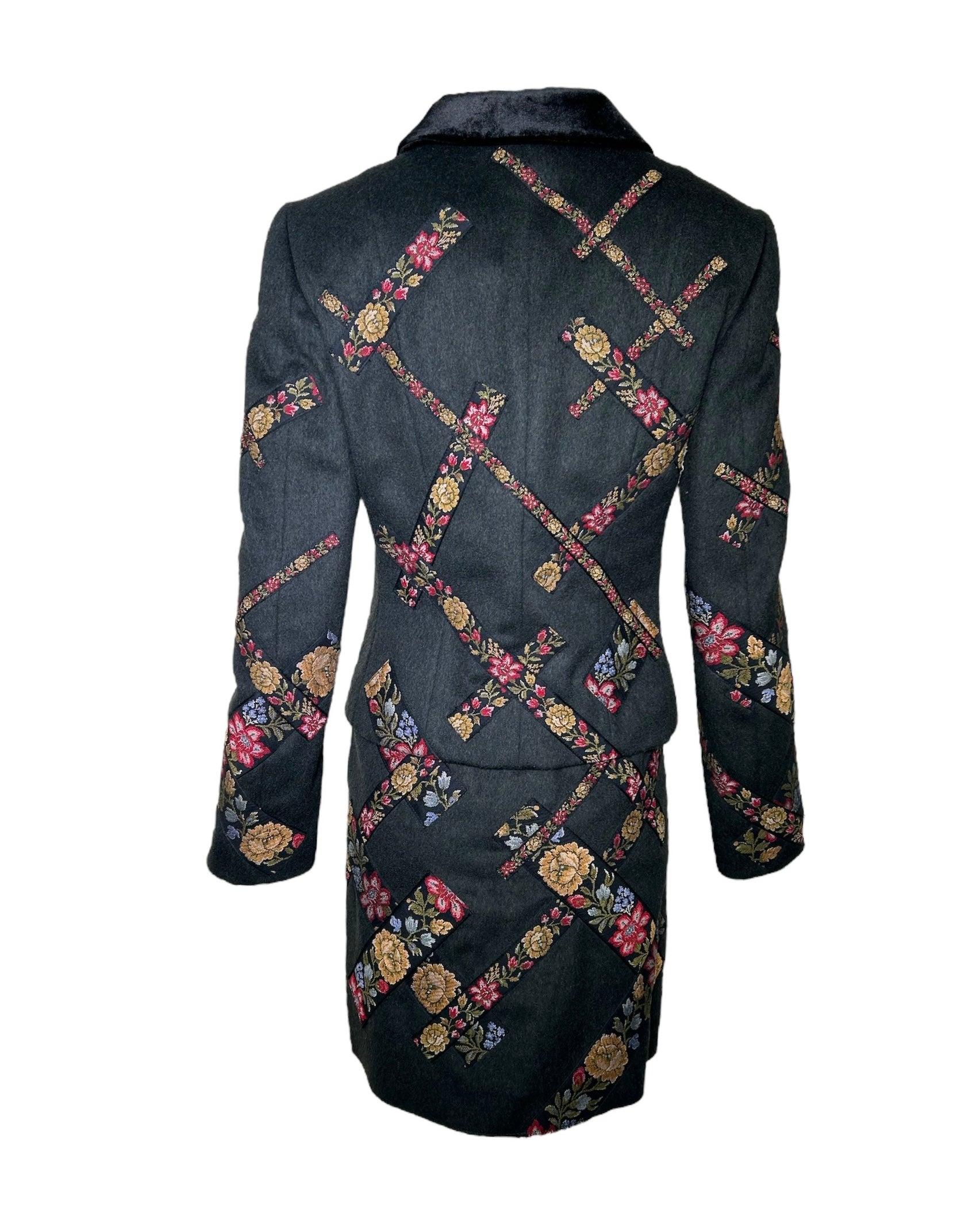 Moschino 1990s Cheap and Chic Wool Suit Ensemble w/Petit-Point Floral Trim.  This suit, crafted in Italy and influenced by Eastern-European petit-point trim strategically placed in a wide diagonal grid to give texture and dimension.  Velvet lapels