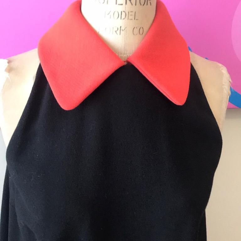 Moschino cheap chic black a-line shift dress

Cute a line shift dress in Wool Crepe ! Great for fall worn with tights and knee high boots. Removable Orange Wool Crepe collar. Slight Racer back.
Size 6
Across chest - 18.5 inches laying flat
Across