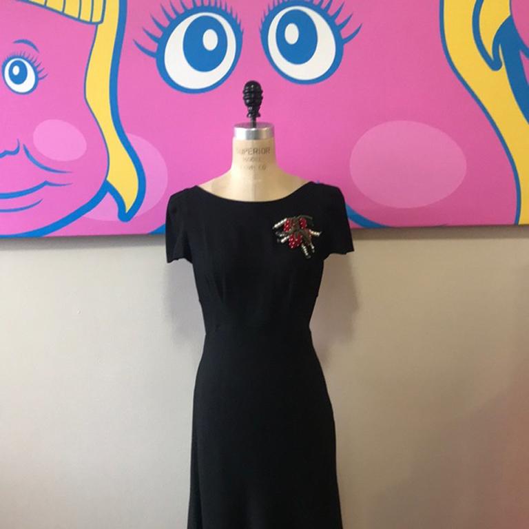 Moschino cheap chic black crepe cocktail dress

This unique dress has. V back and is cut on bias to hug your curves ! Unique velvet strawberry’s in the front shoulder.
Size 12
Across the chest - 19 1/2 in.
Across the waist - 16 in.
Across the hips -