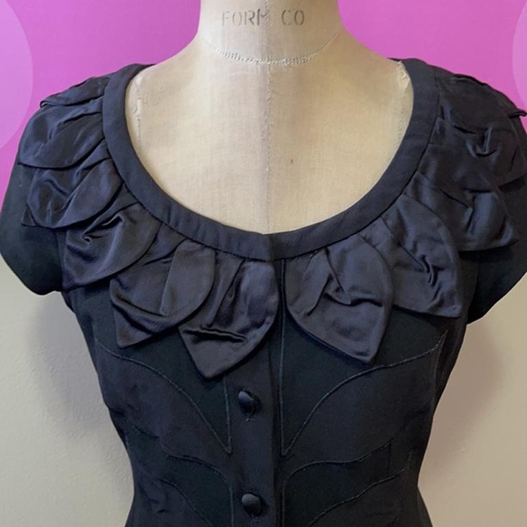 Moschino cheap chic black flower jacket

This adorable sleeveless jacket has flower pedals all around the collar and embroidered leaves on the front. Pair with black pencil skirt or pencil pants for a finished look. 
Size 8 - Brand runs small please