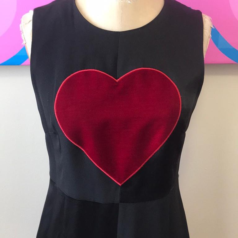 Moschino cheap chic black satin red heart dress

Iconic Moschino satin dress with red velvet heart design. Fit and flare design . As wearable today as when it was made, vintage 1990s. Brand runs small. 
Size 6

Across chest - 17 inches laying
