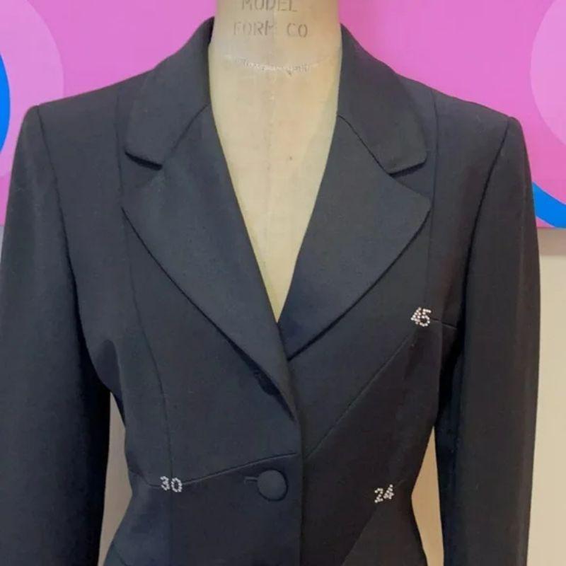 Moschino cheap chic black tuxedo jacket blazer

Be retro cool wearing this vintage tuxedo style blazer / Jacket by the Moschino Cheap and Chic line! Really interesting design that has random number around the front and back. Pair with black skinny