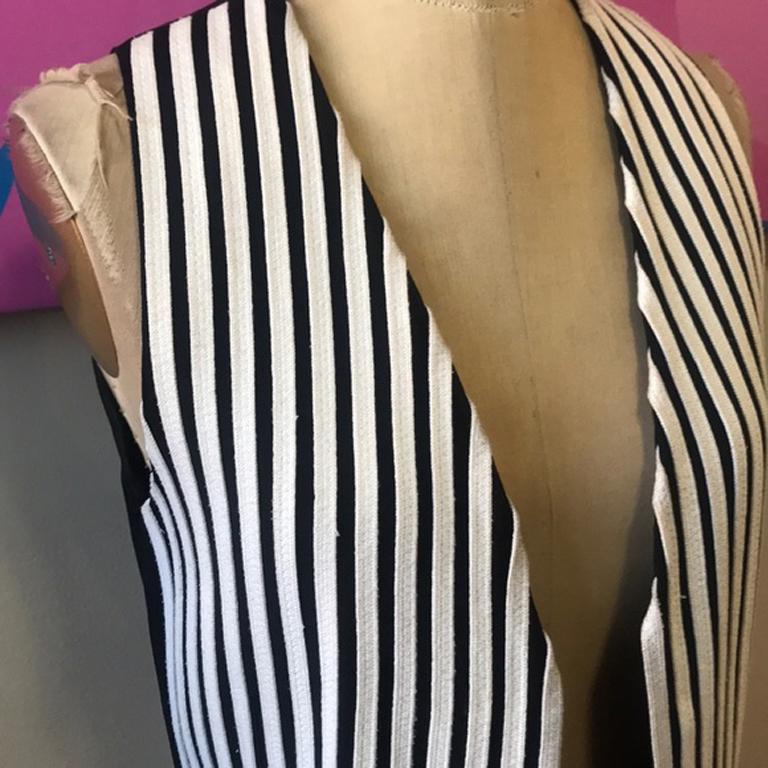 Moschino cheap chic black white shoe lace vest

Be retro cool this Fall wearing this vintage black vest with white shoestrings paired with black skinny pants and boots over a white long sleeve shirt.
Size 8
Across chest -16 1/2 in.
Across waist - 15