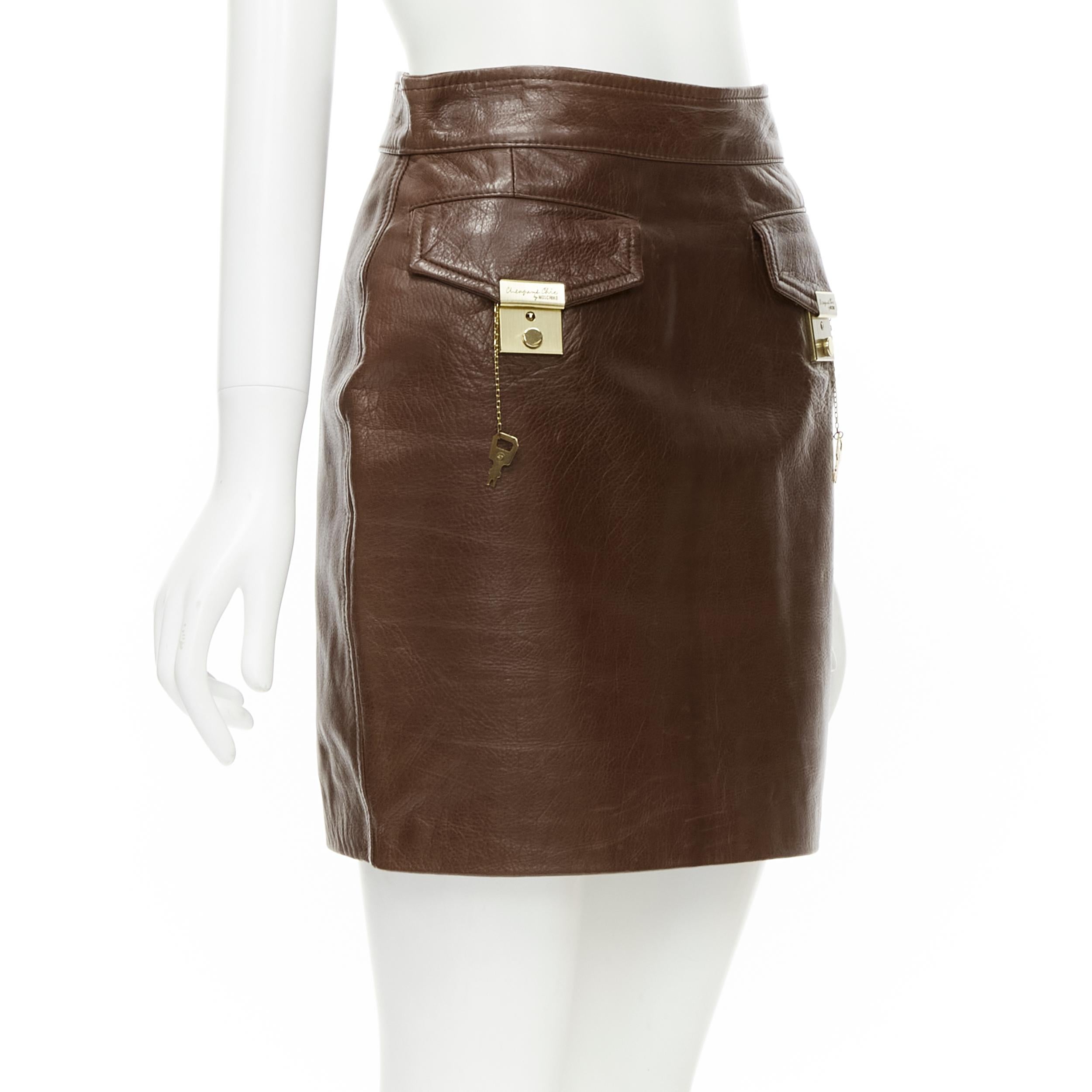 MOSCHINO Cheap Chic brown gold leather key lock flap pocket skirt S 
Reference: JECN/A00014 
Brand: Moschino 
Material: Leather 
Color: Brown 
Pattern: Solid 
Closure: Zip 
Extra Detail: Gold-tone lock design on flap pocket. Button zip back closure.